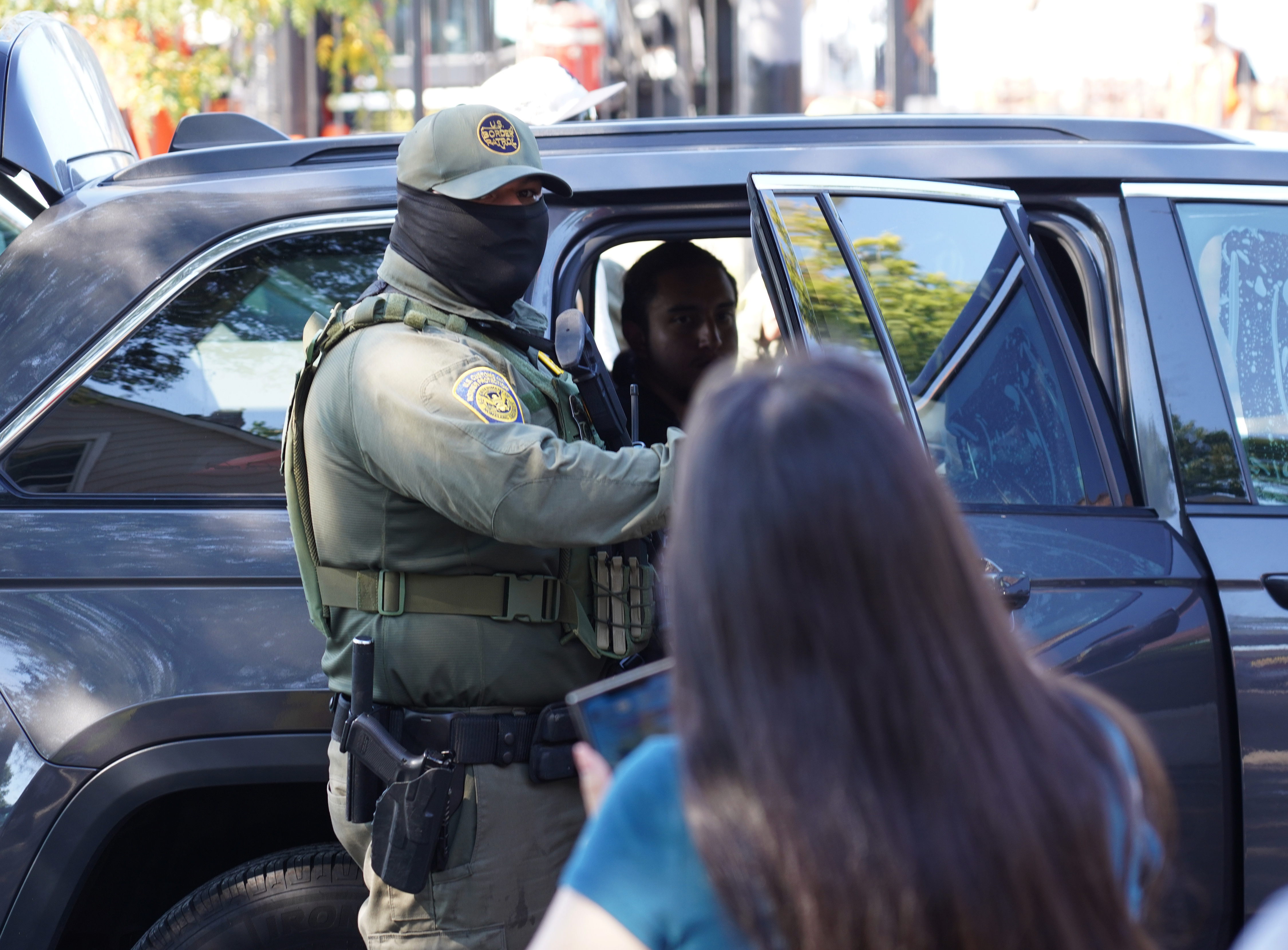 Elizabeth Ruiz pleads with a U.S. Border Patrol agent for...