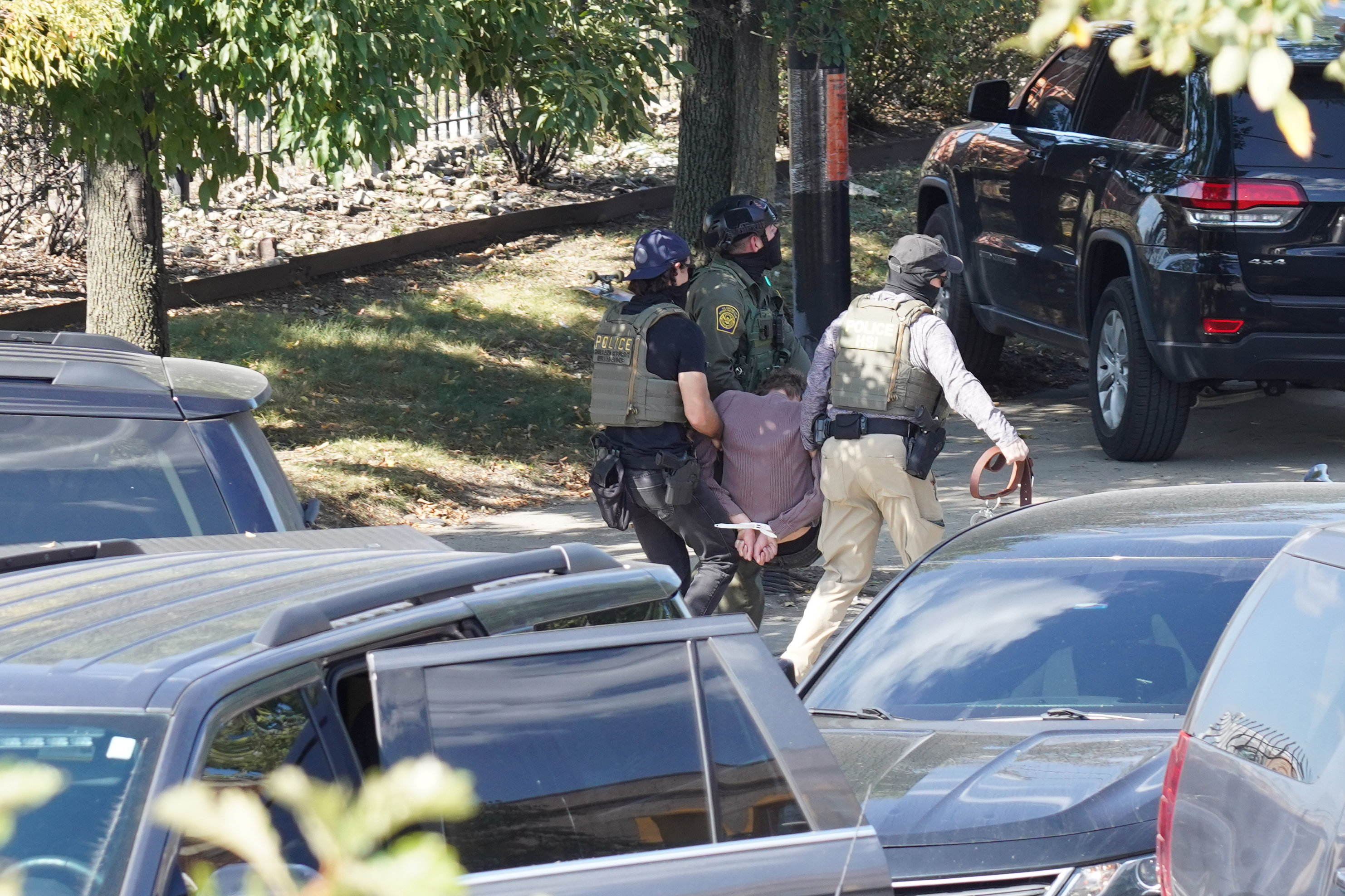 Detainees are brought to the side of the road as...