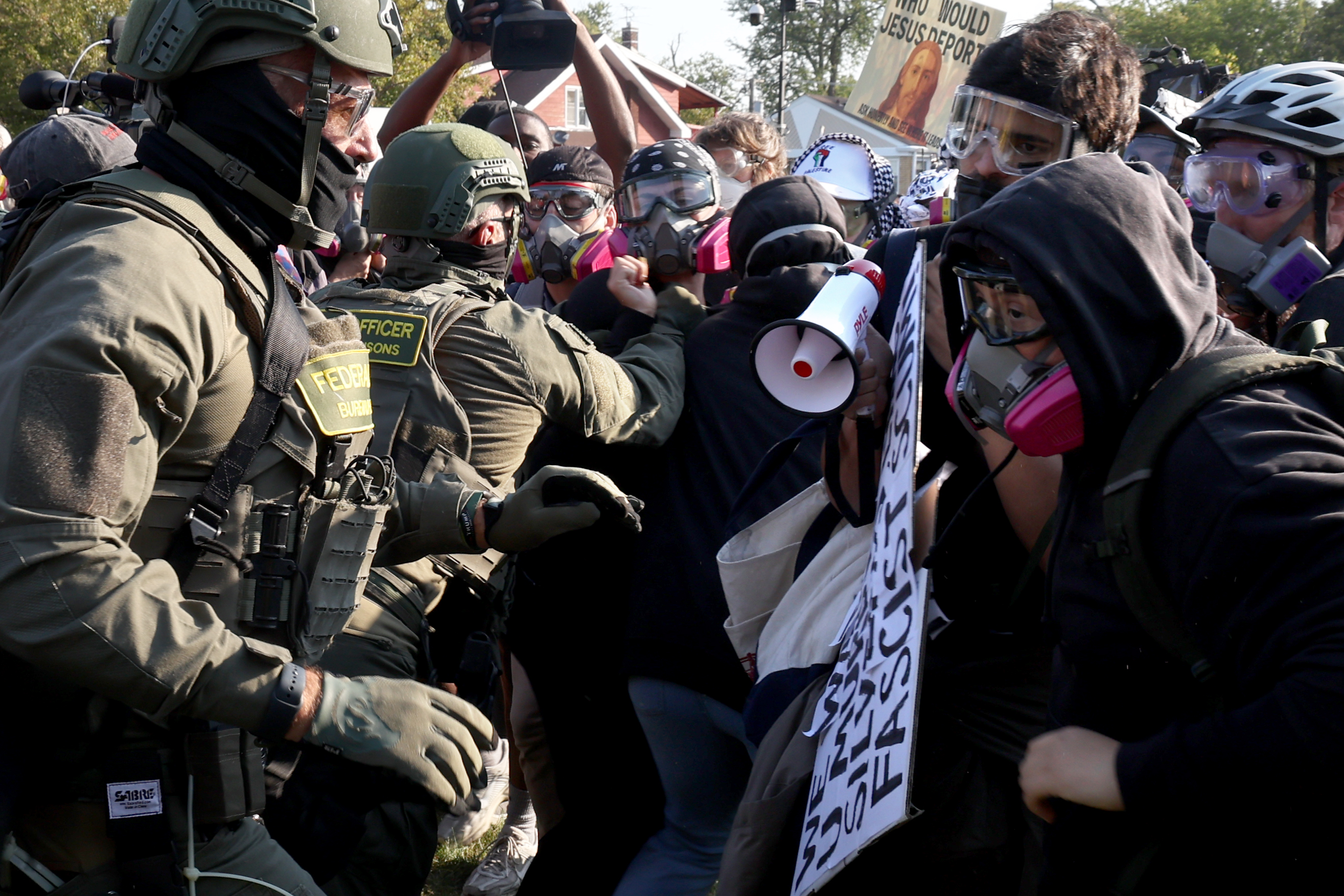 Protesters clash with federal agents and Illinois State Police troopers...