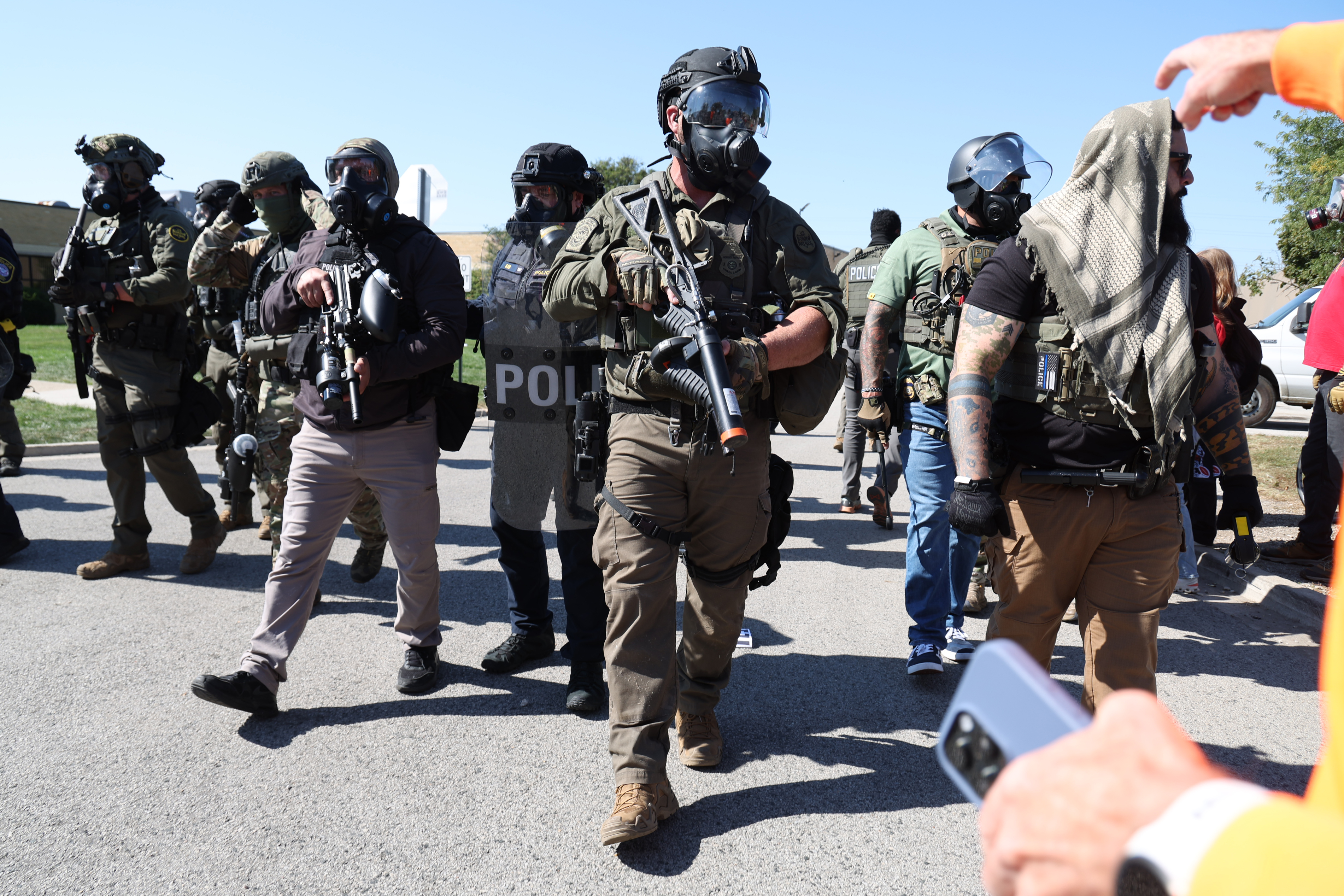 Federal agents move toward protesters at 25th Street near the...