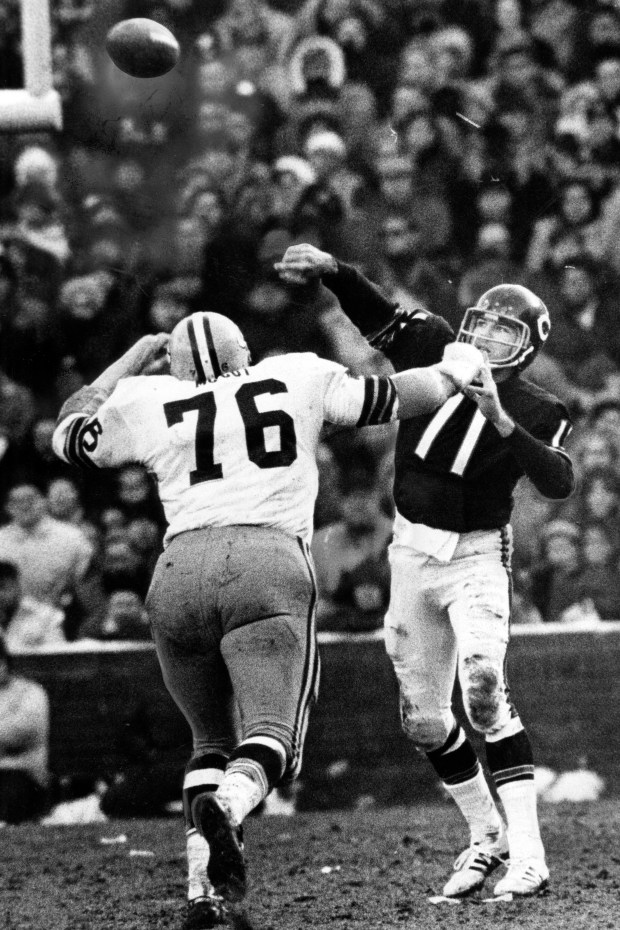 Chicago Bears quarterback Jack Concannon gets the pass off before Green Bay Packers tackle Mike McCoy can get to him. Concannon enjoyed a fine day, completing 21 of 34 passes at Wrigley Field on Dec. 13, 1970. The Bears beat the Packers 35-17. (Chicago Tribune historical photo)