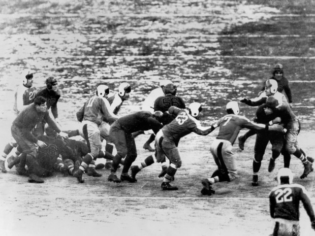 The New York Giants attempt to wrestle the Chicago Bears' Bronko Nagurski, far right, to the ground during a football game at the Polo Grounds in New York on Dec. 9, 1934. New York won 30-23. (UPI)