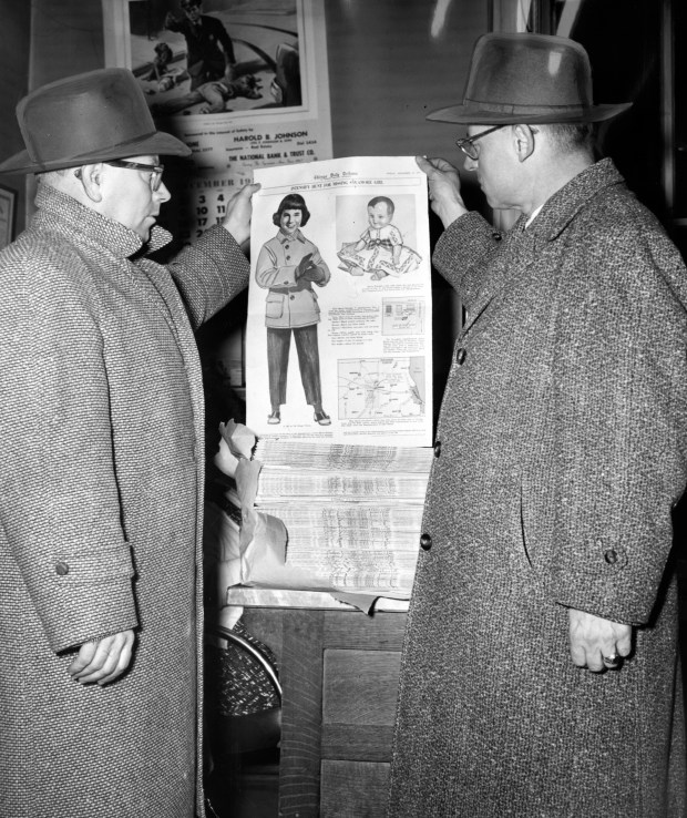 Sycamore Mayor Harold Johnson, left, and Assistant State's Attorney James Boyle view a color page on Dec. 13, 1957, of the Chicago Tribune, which showed the important facts in the disappearance of Maria Ridulph. (Weldon Whisler/Chicago Tribune)