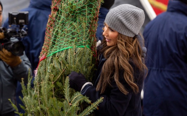 U.S. Secretary of Homeland Security Kristi Noem carries a Christmas tree to load it into a truck during the 25th Anniversary Voyage of Chicago's Christmas Ship, USCGC Mackinaw, Dec. 6, 2025, at Polk Brothers Park. The Christmas trees were later donated to local families in need. (Dominic Di Palermo/Chicago Tribune)