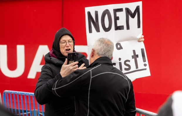 A demonstrator is removed from Polk brothers Park after protesting U.S. Secretary of Homeland Security Kristi Noem's appearance at the 25th Anniversary Voyage of Chicago's Christmas Ship, USCGC Mackinaw, Saturday, Dec. 6, 2025, near Chicago's Lake Michigan. (Dominic Di Palermo/Chicago Tribune)