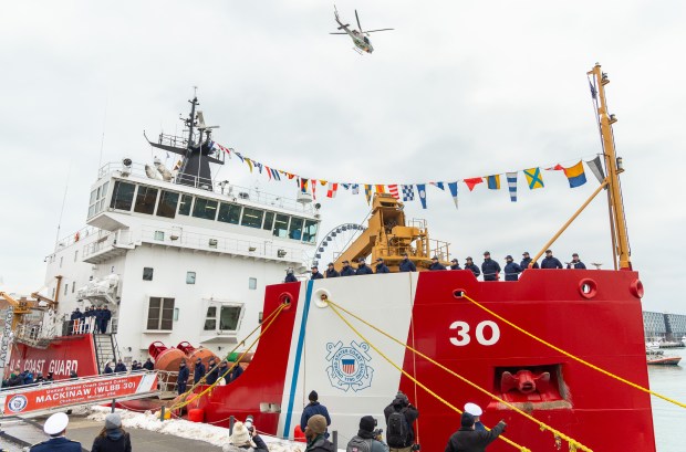 A Chicago Fire Department Helicopter flies over the USCGC Mackinaw before dropping a ceremonial wreath into Lake Michigan during the 25th Anniversary Voyage of Chicago's Christmas Ship, USCGC Mackinaw, Dec. 6, 2025, at Polk Brothers Park in Chicago. The ceremonial wreath is dropped in the lake to honor the crew of the Rouse Simmons, a Christmas ship that sank in the lake while delivering Christmas trees in 1912. (Dominic Di Palermo/Chicago Tribune)