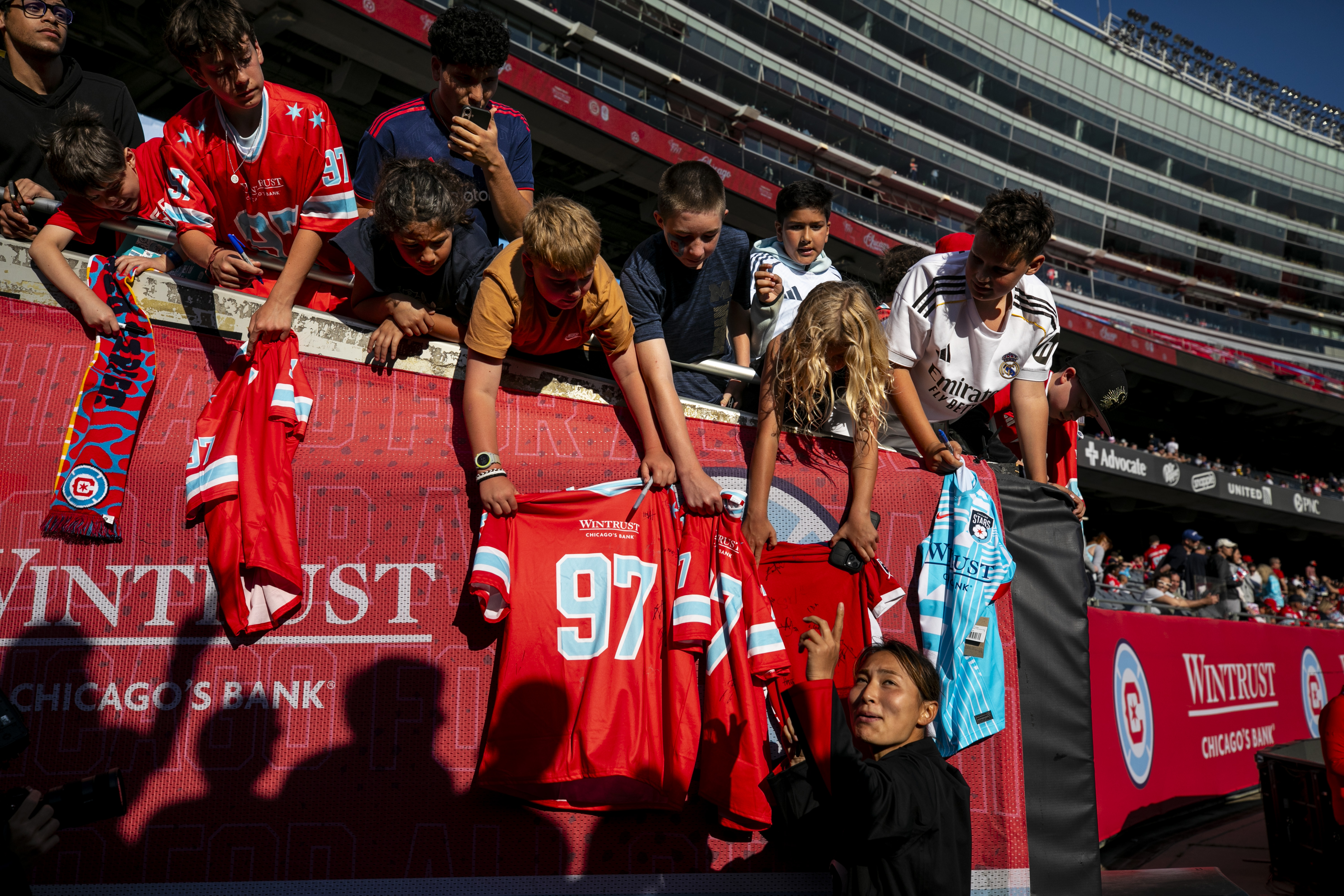 Manaka Hayashi of the Chicago Stars signs jerseys after a...