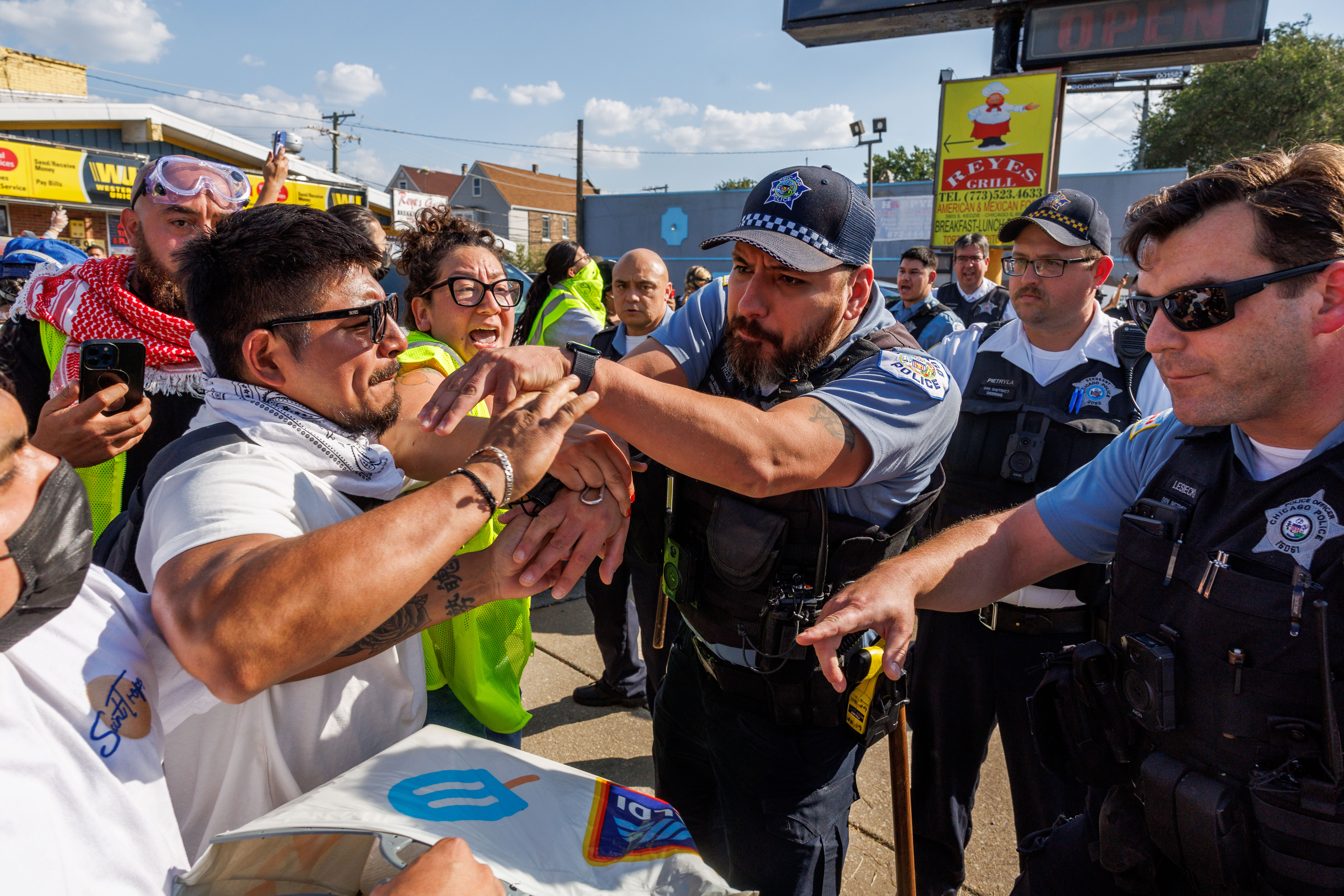 Chicago police push back community members and activists while the...
