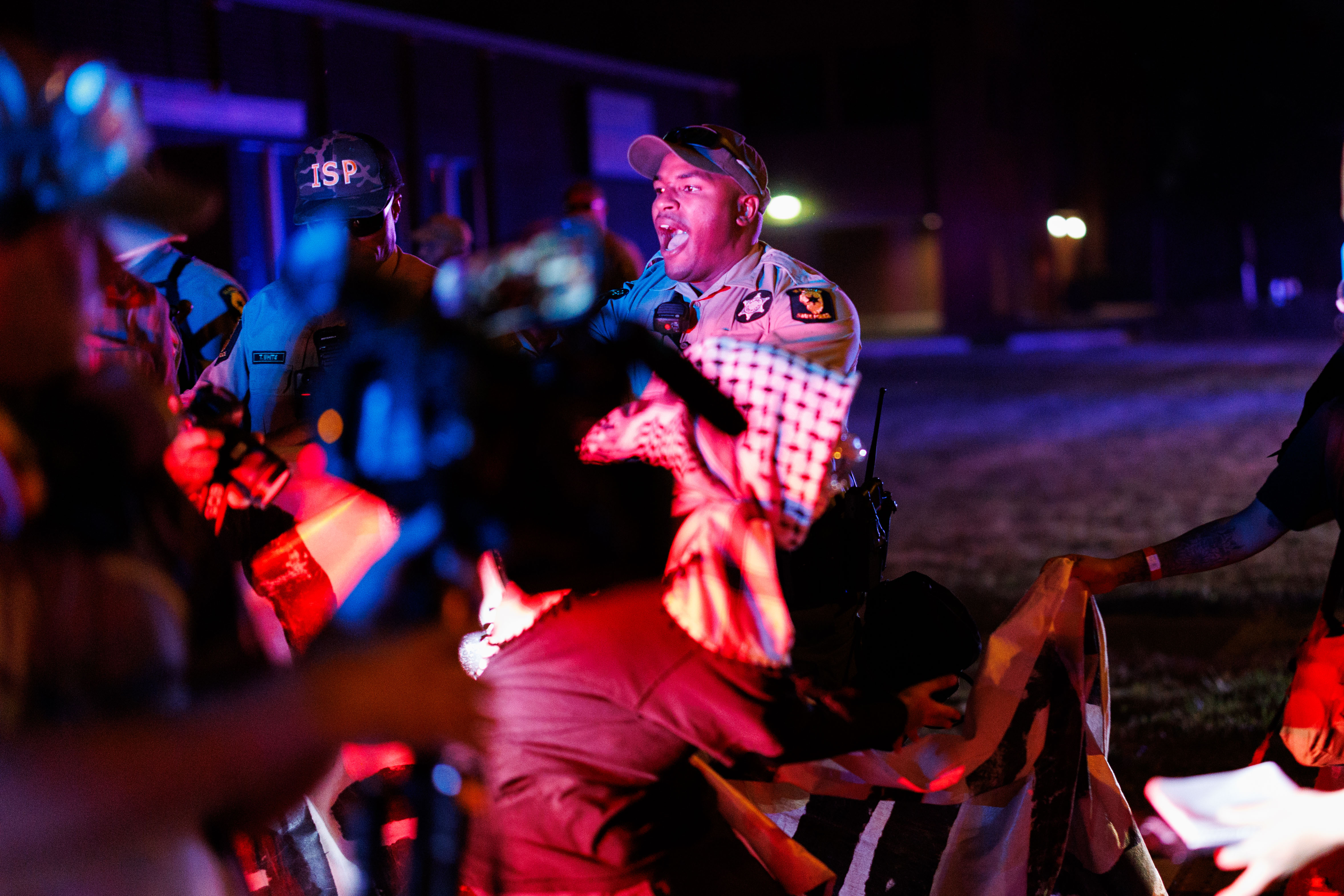 Illinois State Police move protesters off the road near the...