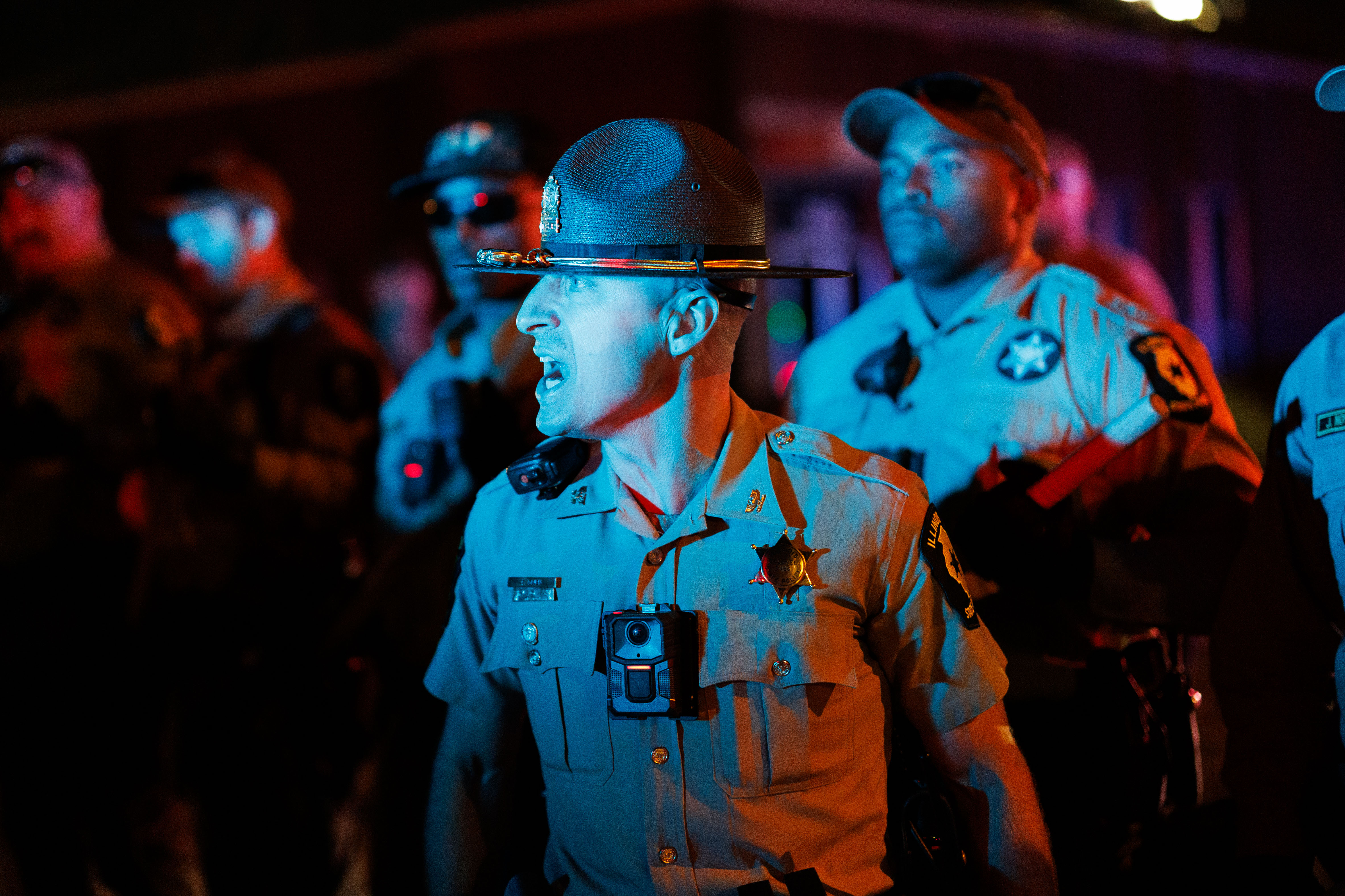 Illinois State Police move protesters off the road near the...
