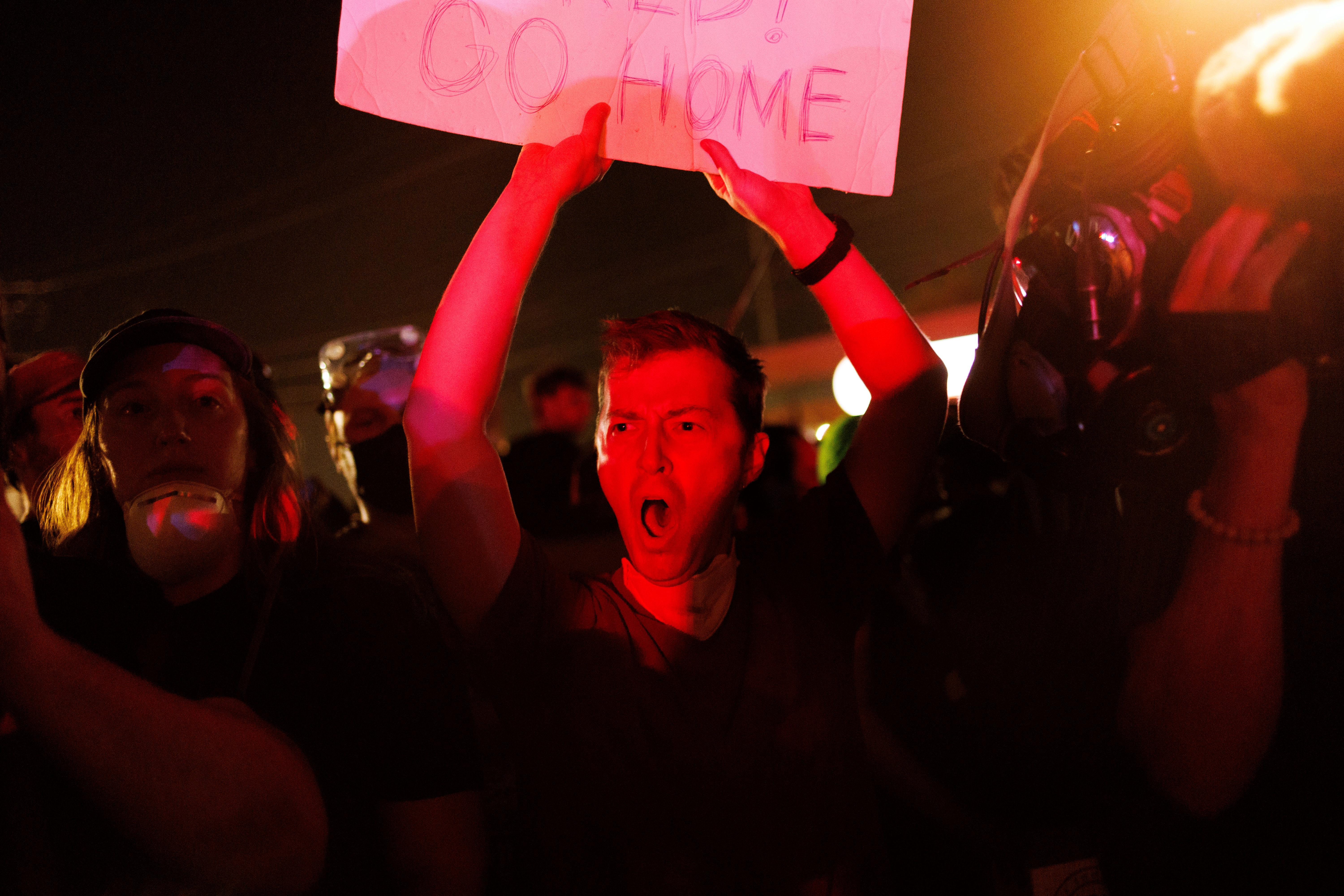 U.S. Immigration and Customs Enforcement holding facility Activists yell at...