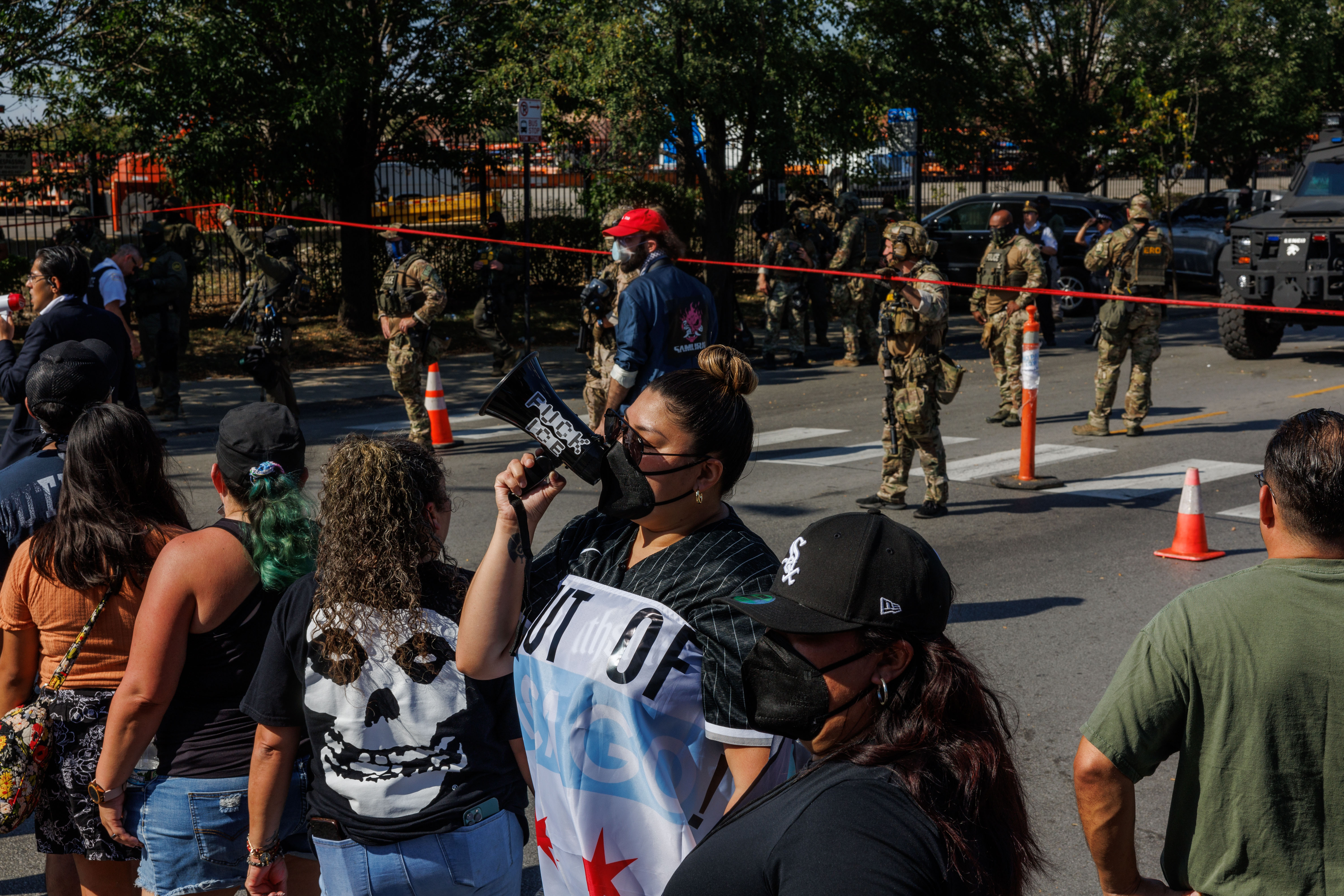 Community members and activists protest federal agents' actions after a...