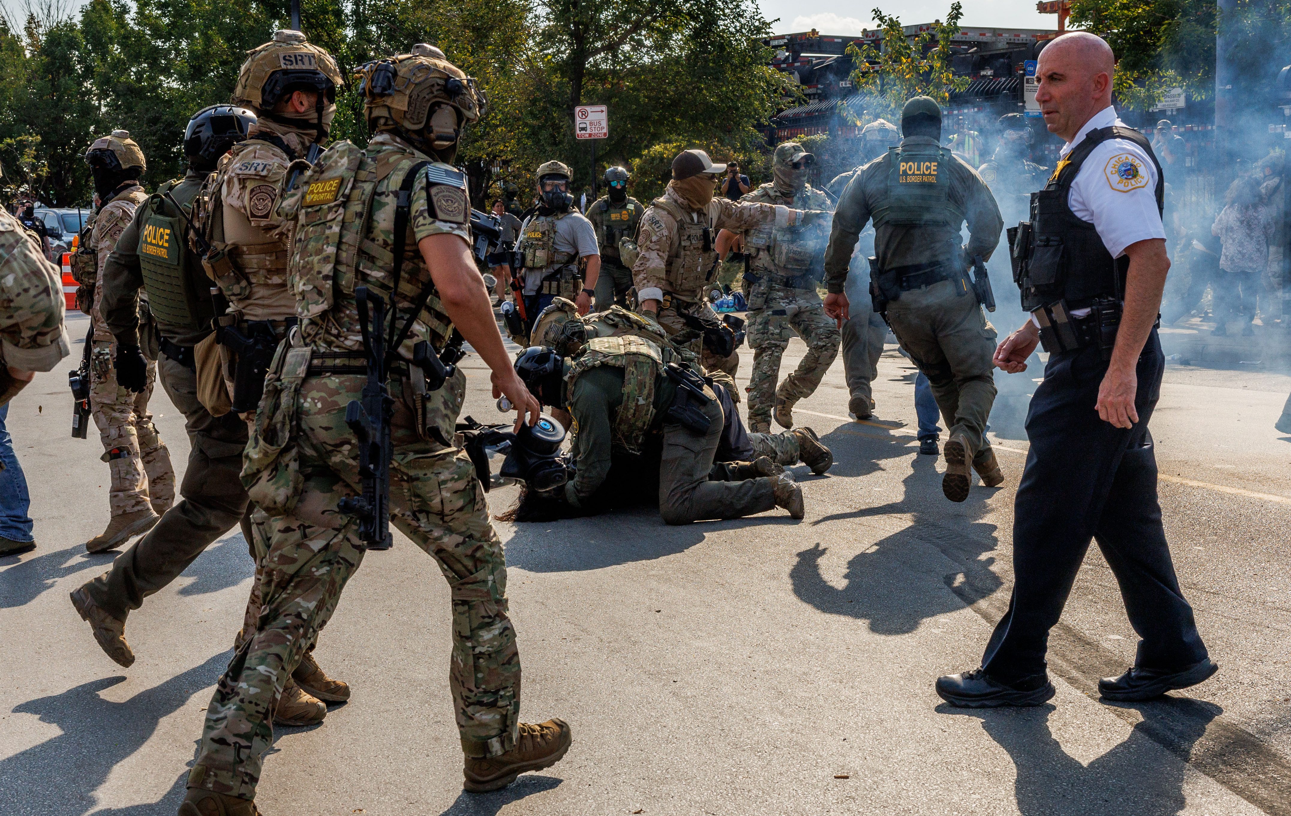 Chicago police watch as federal agents detain people while community...