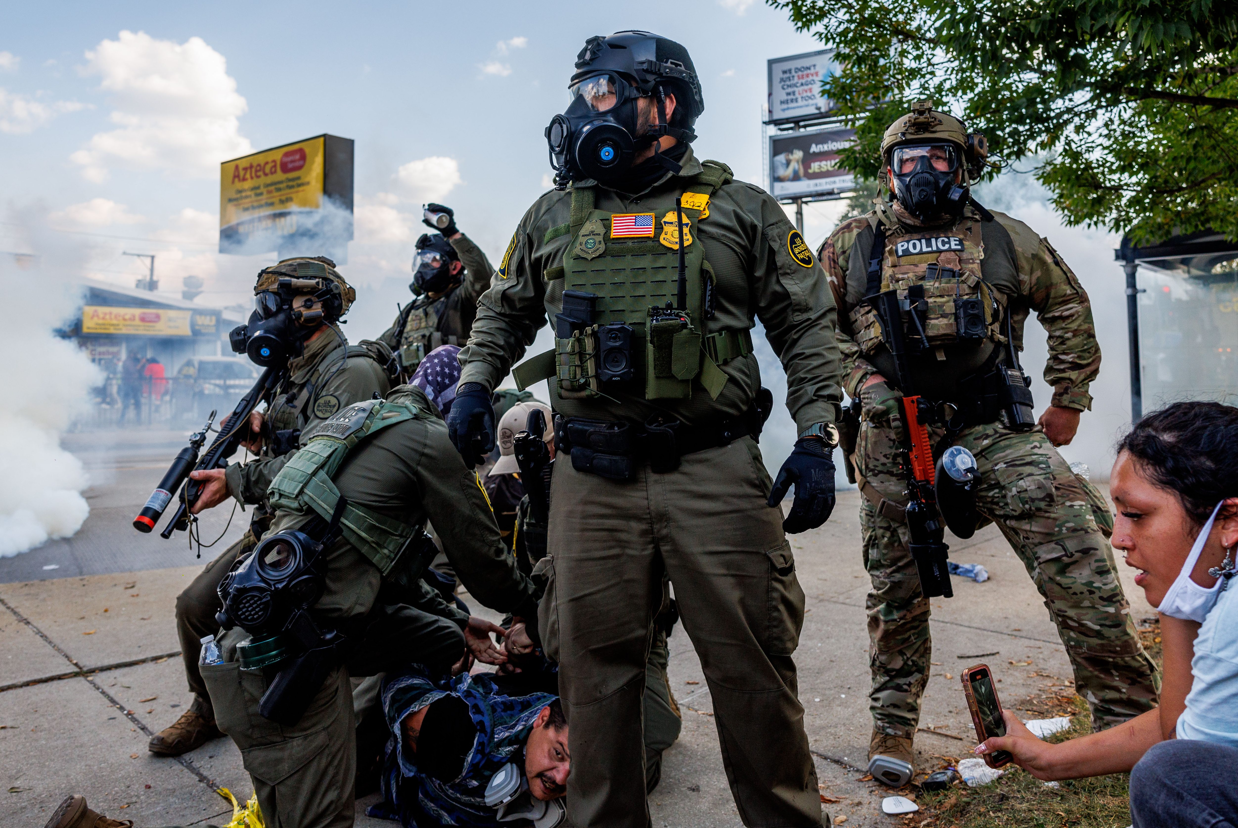 Federal agents detain a person near the 3900 block of...