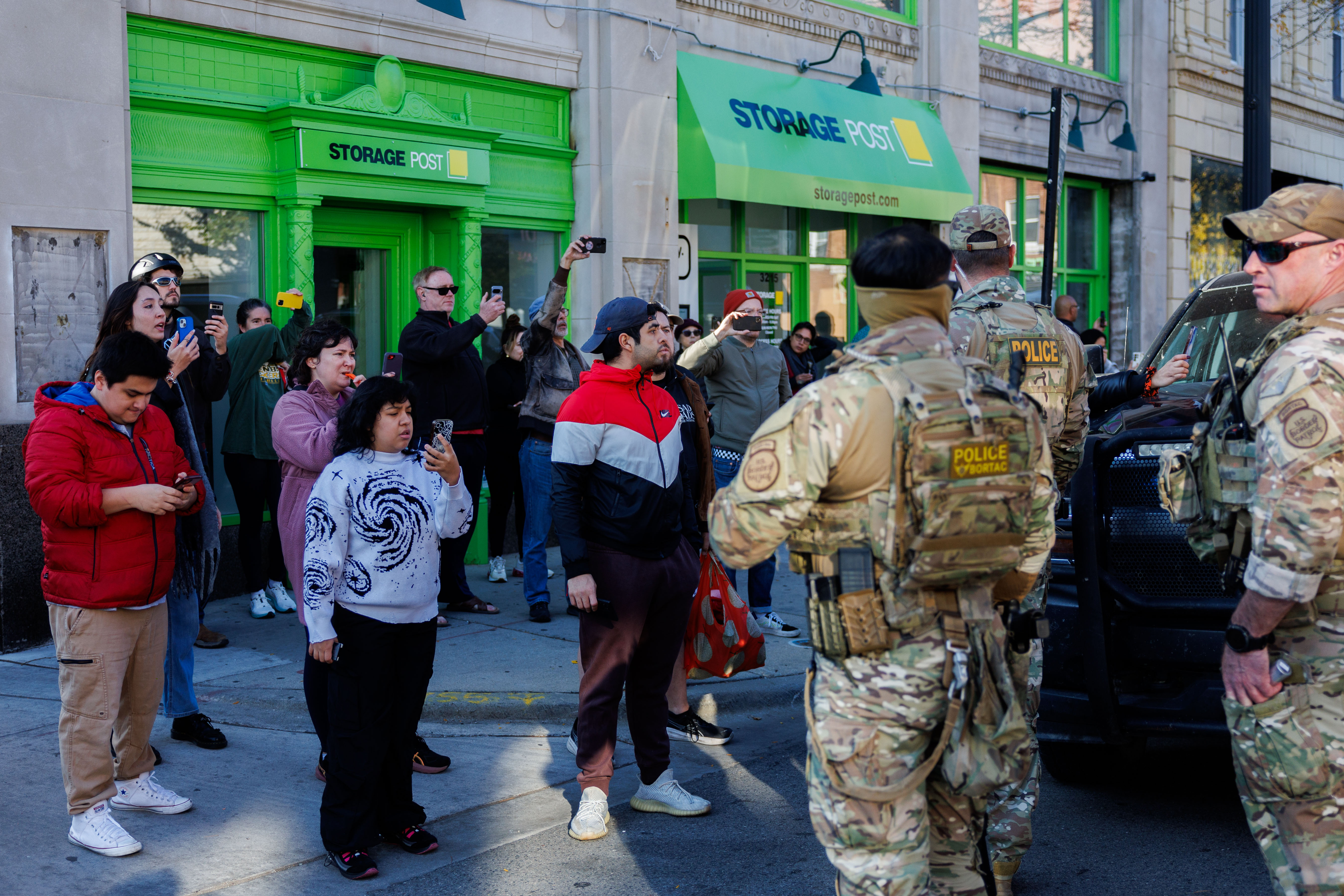Members of the community film Border Patrol officers while they...