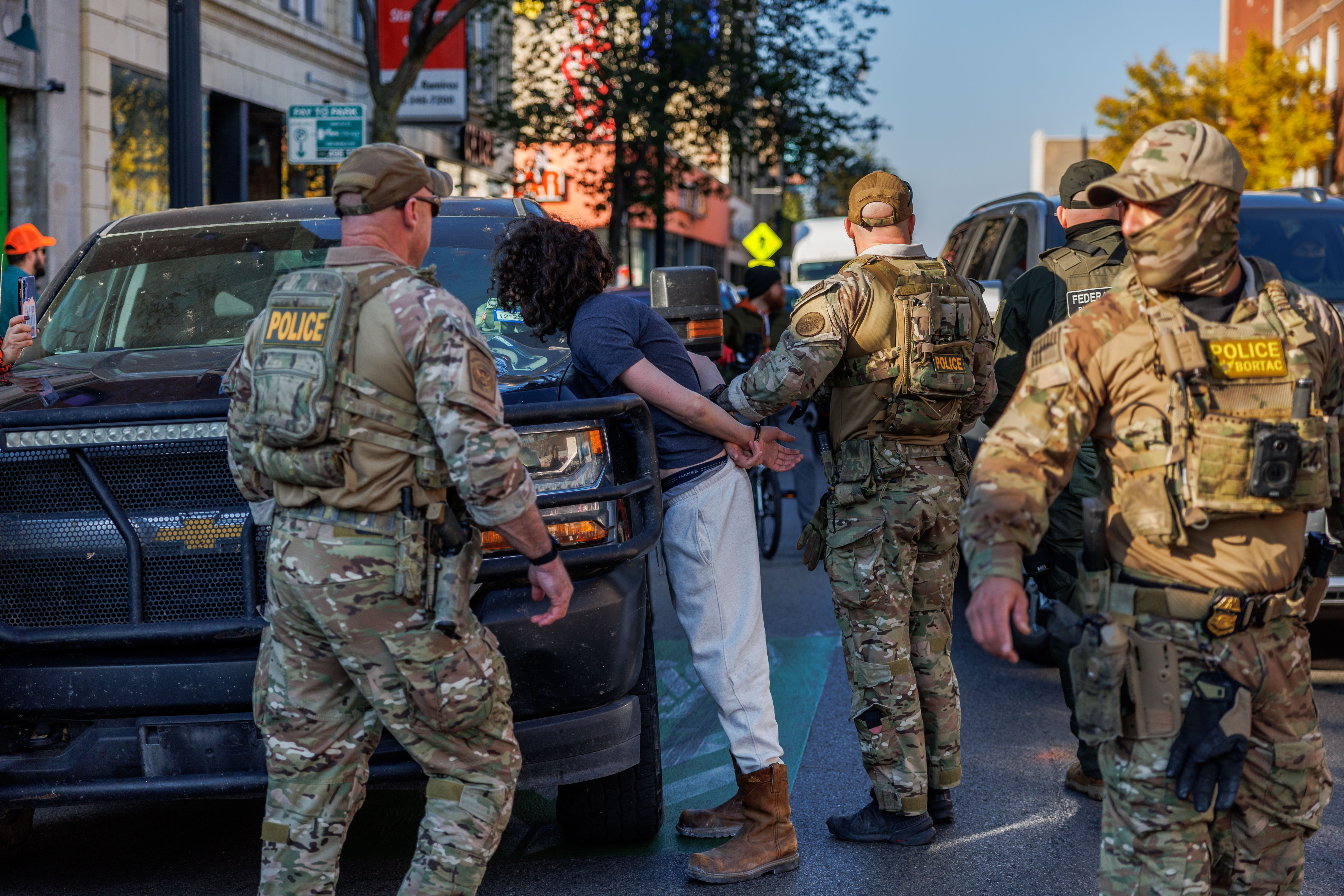 Border Patrol officers detain a person in the Albany Park...