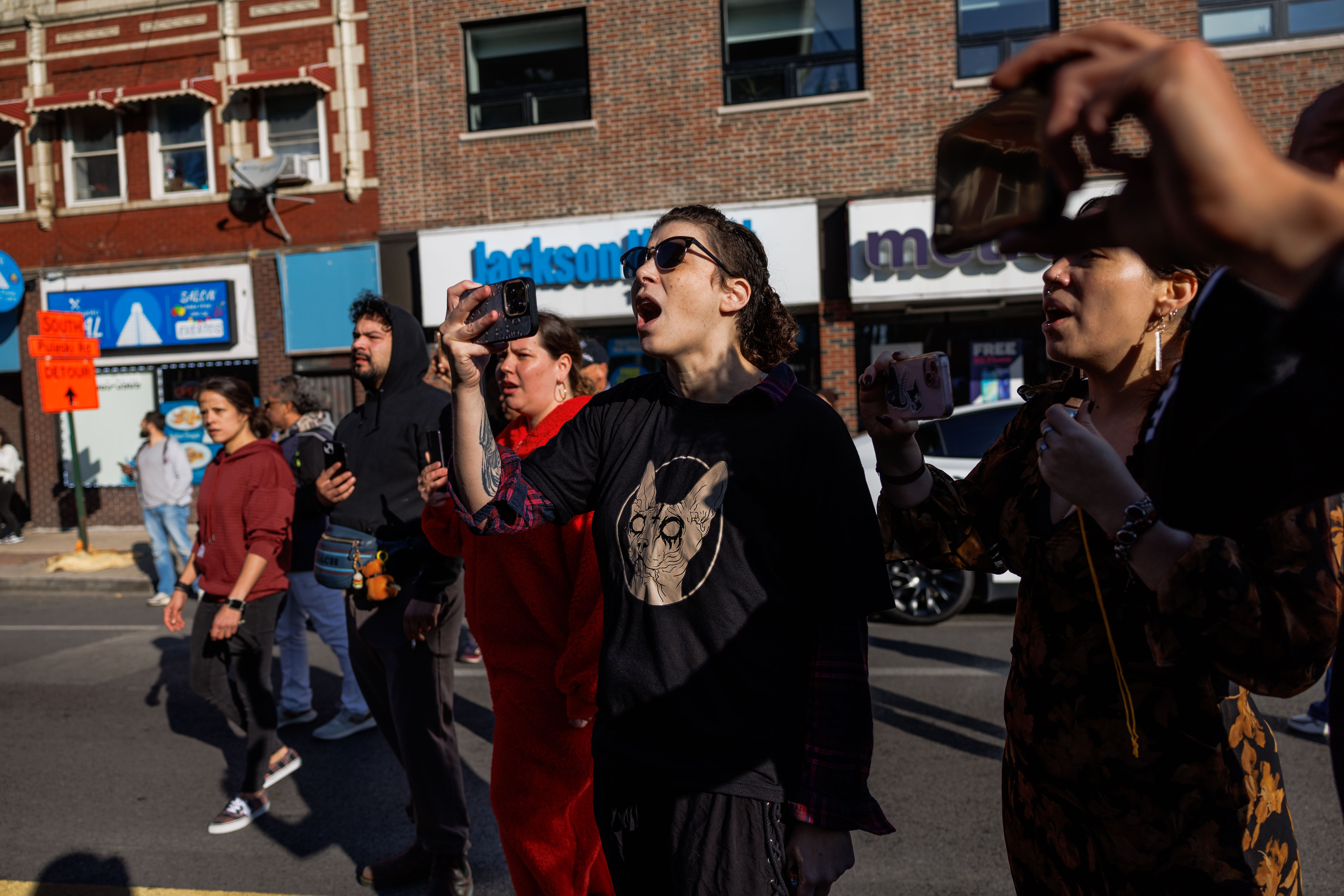 Members of the community yell at U.S. Border Patrol officers...