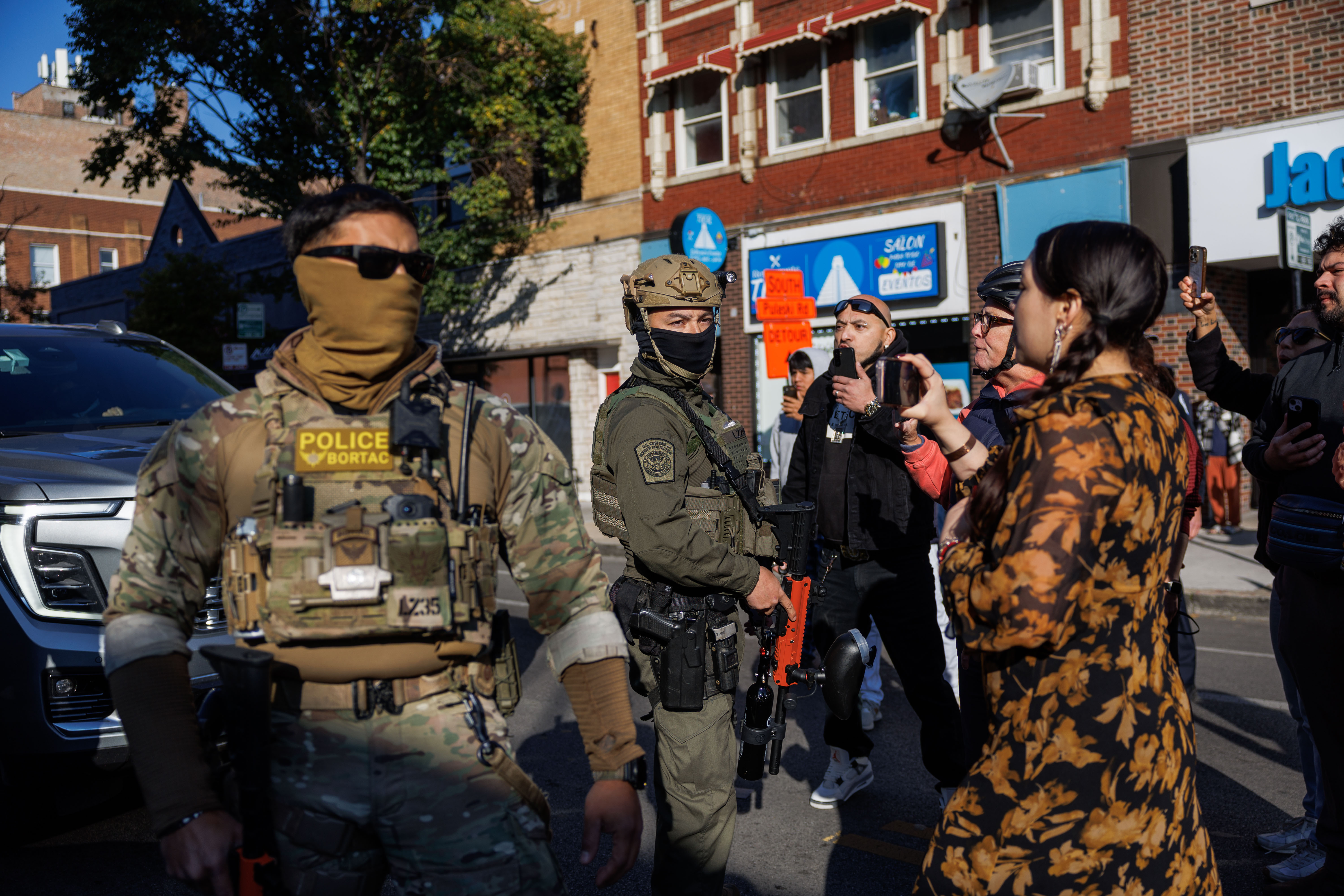Members of the community film Border Patrol officers while they...