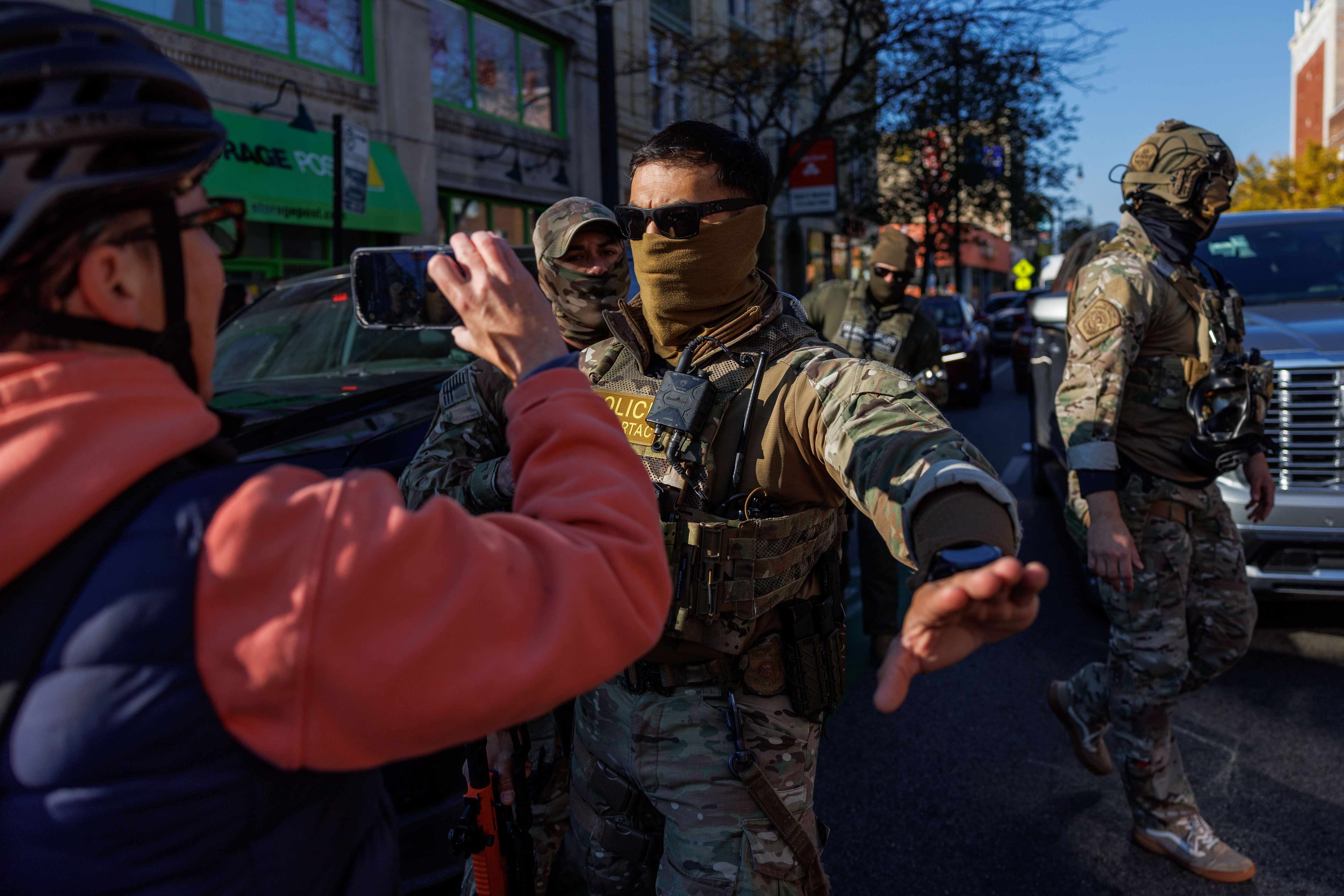 Members of the community film Border Patrol officers while they...