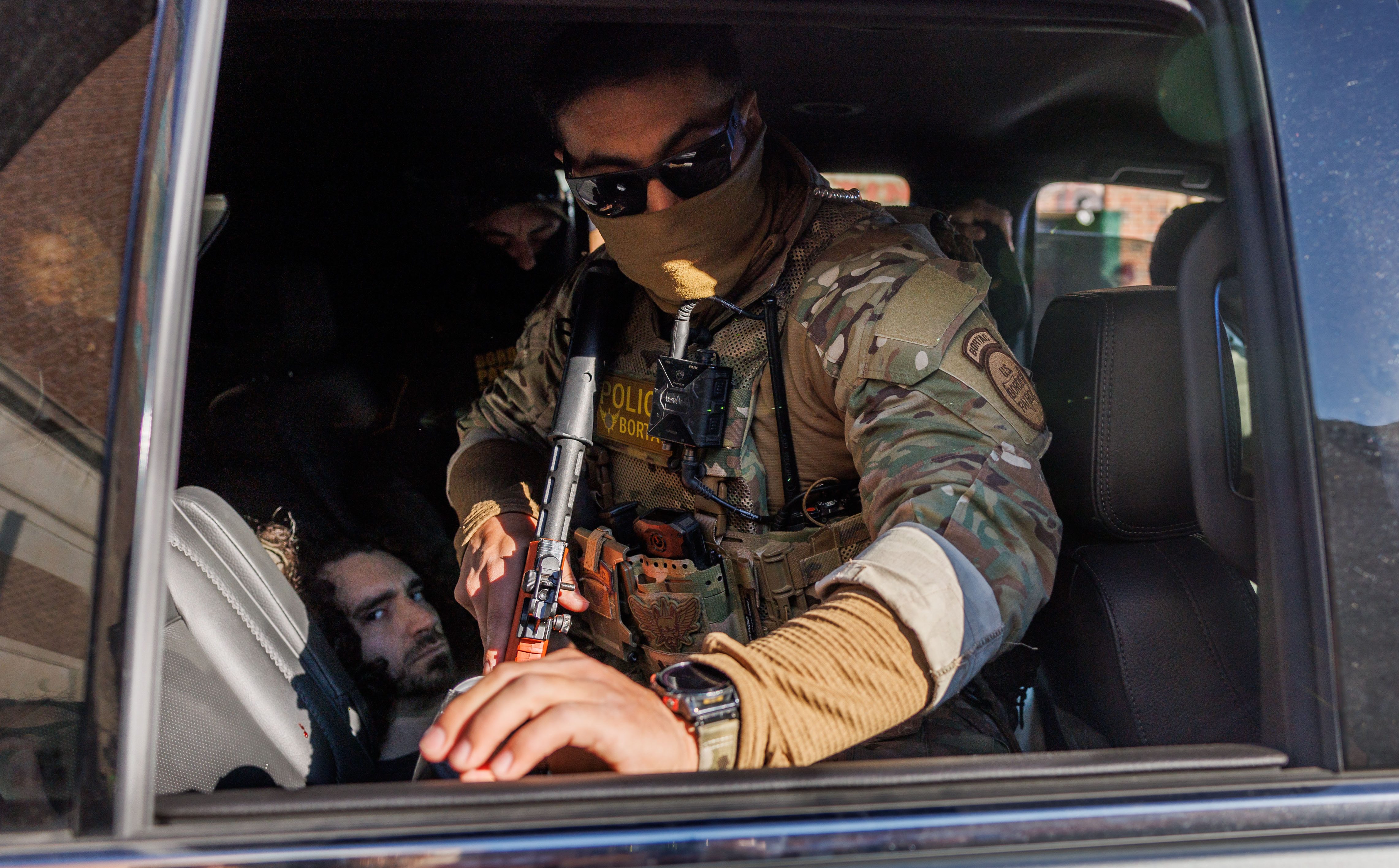 Border Patrol officers detain a person in the Albany Park...