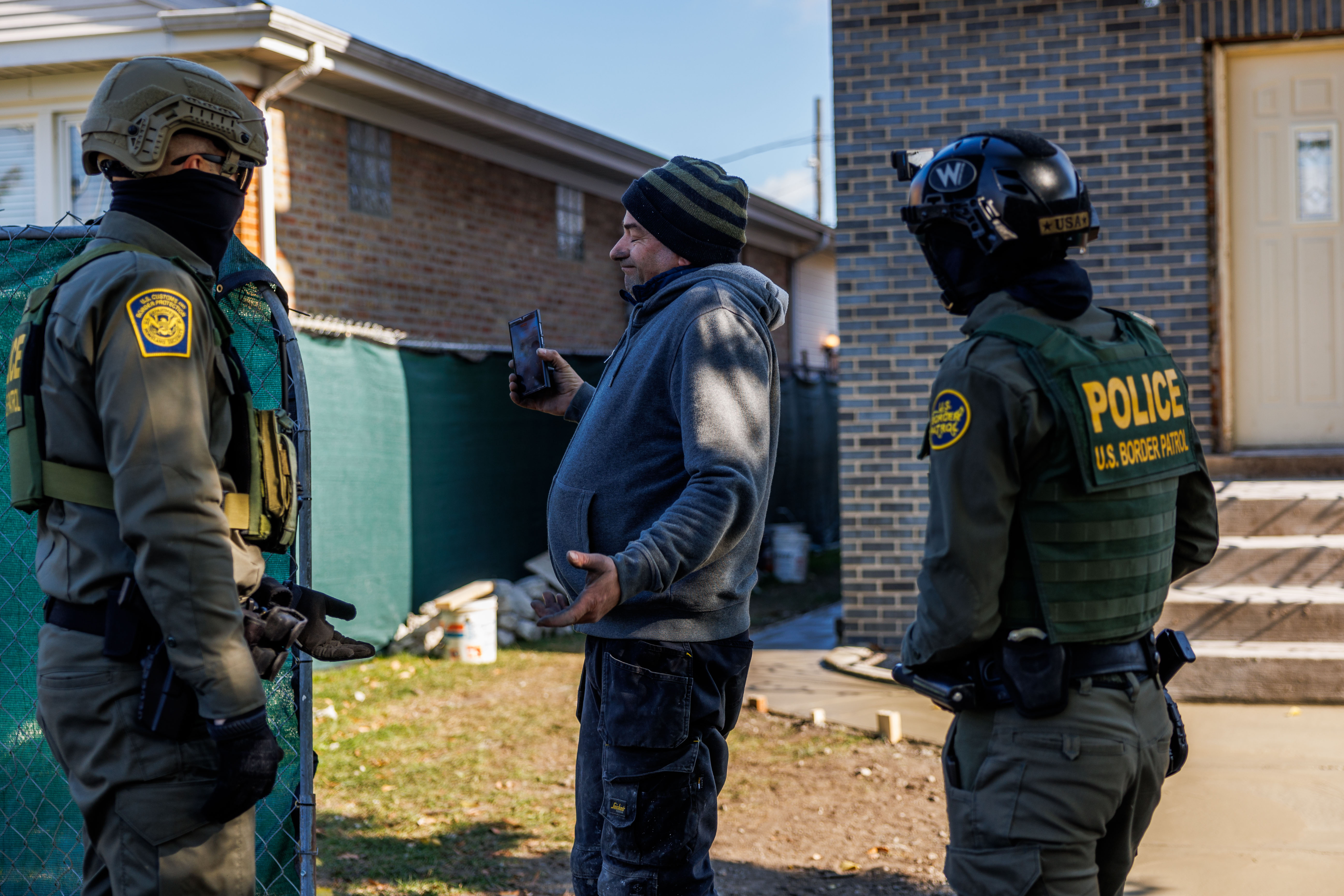 Border Patrol officers question a man about his immigration status...