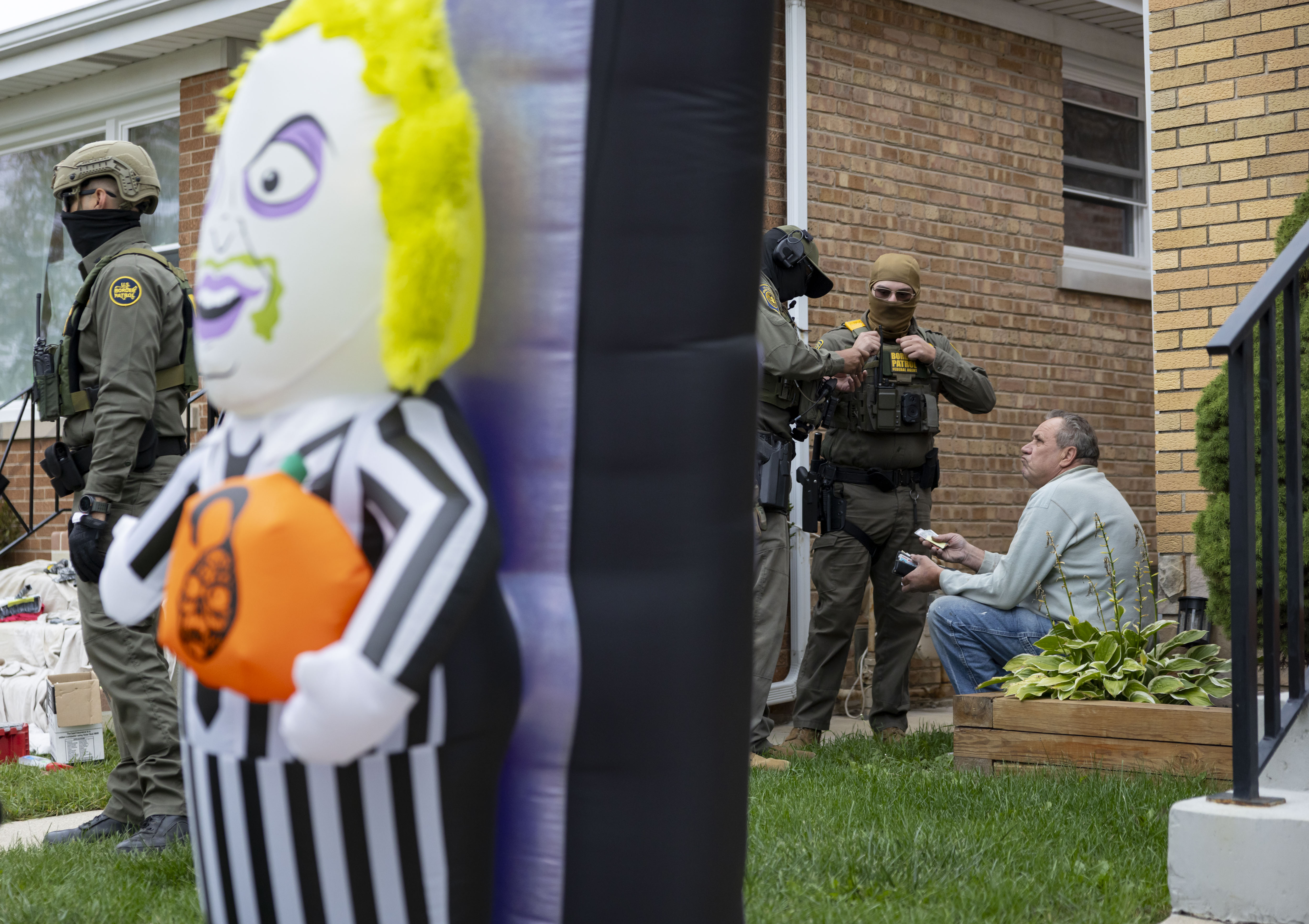 Border Patrol agents question painter Krzysztof Klim for his identification...