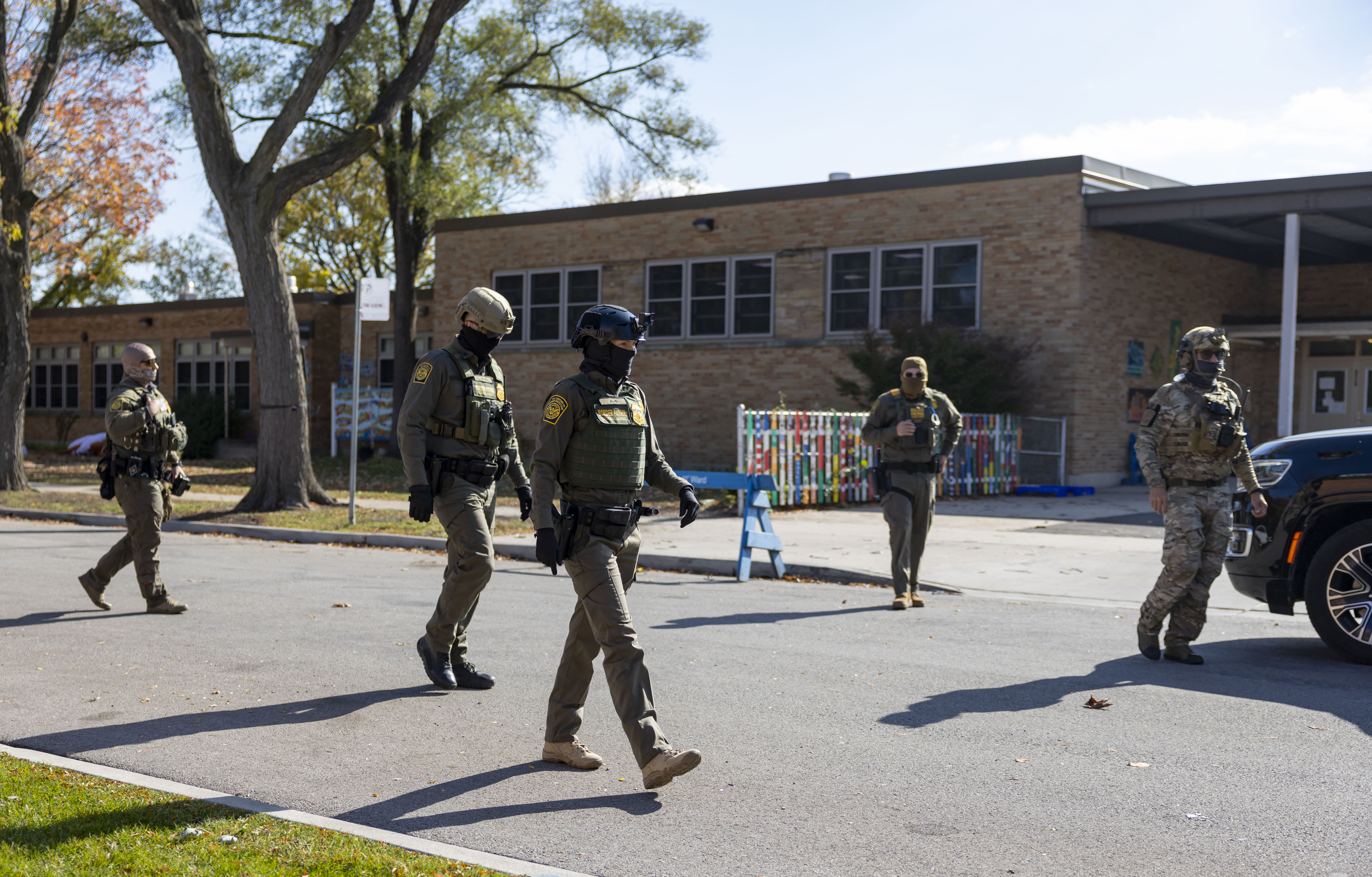 U.S. Border Patrol agents leave after detaining a man working...