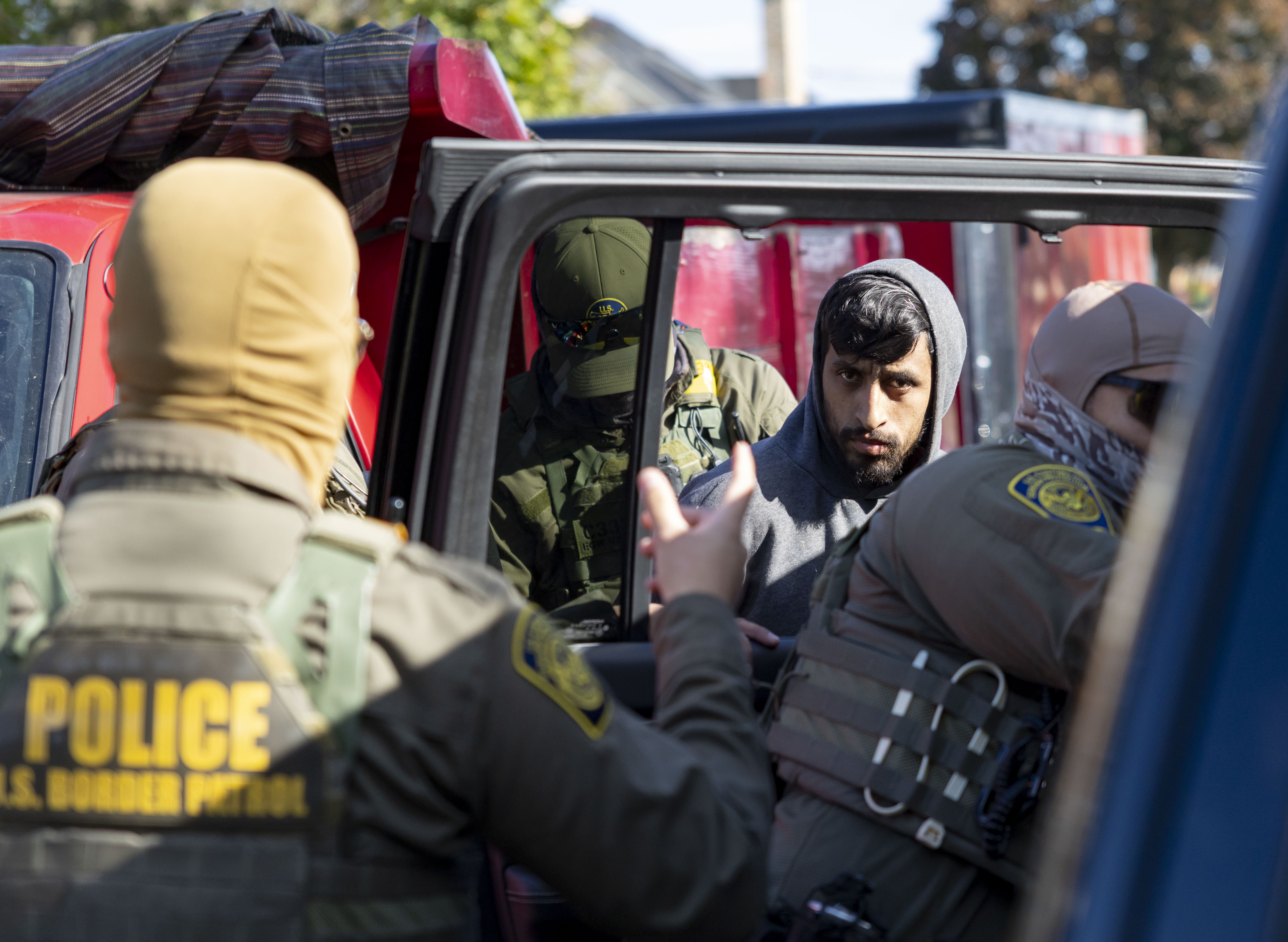 A landscaper is detained by U.S. Border Patrol agents during...