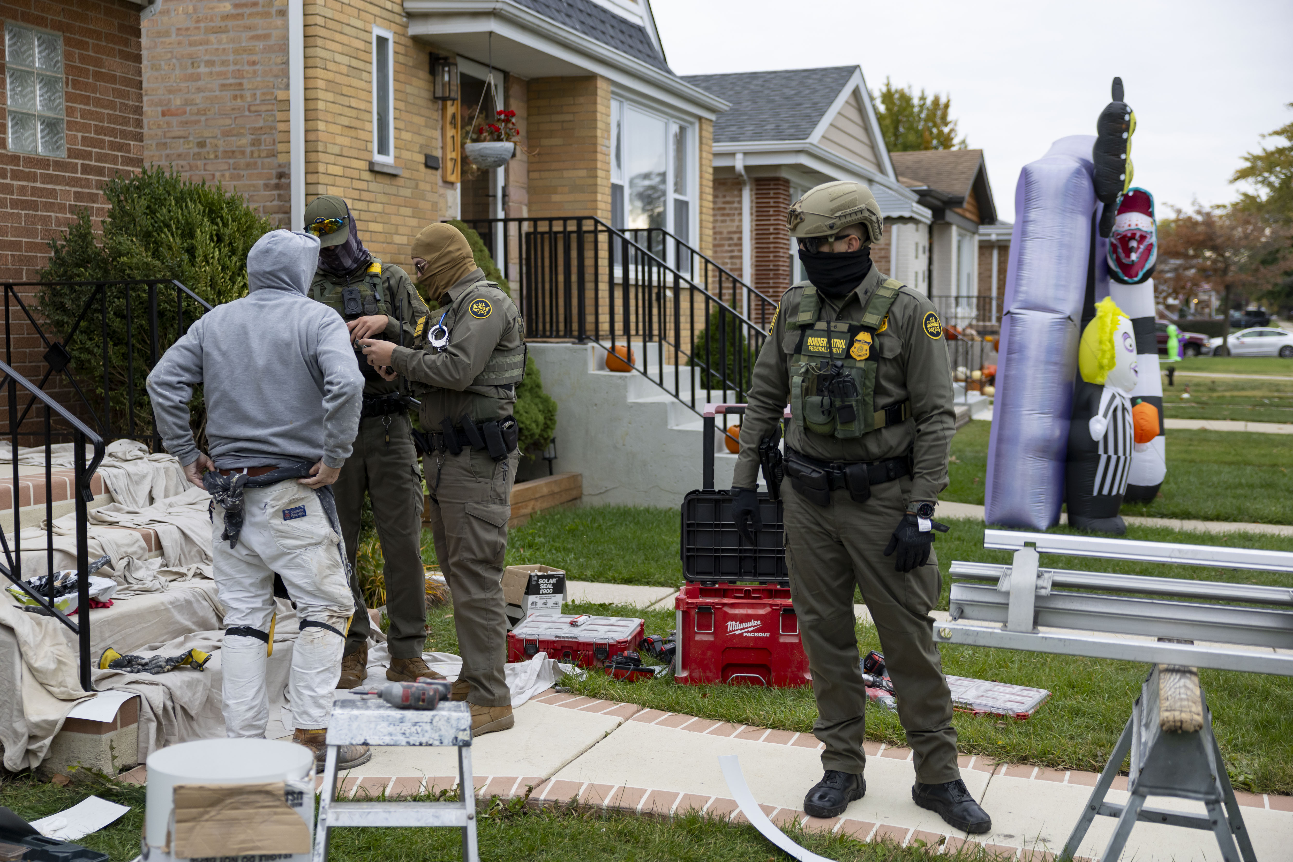 U.S. Border Patrol agents question and detain a man they...