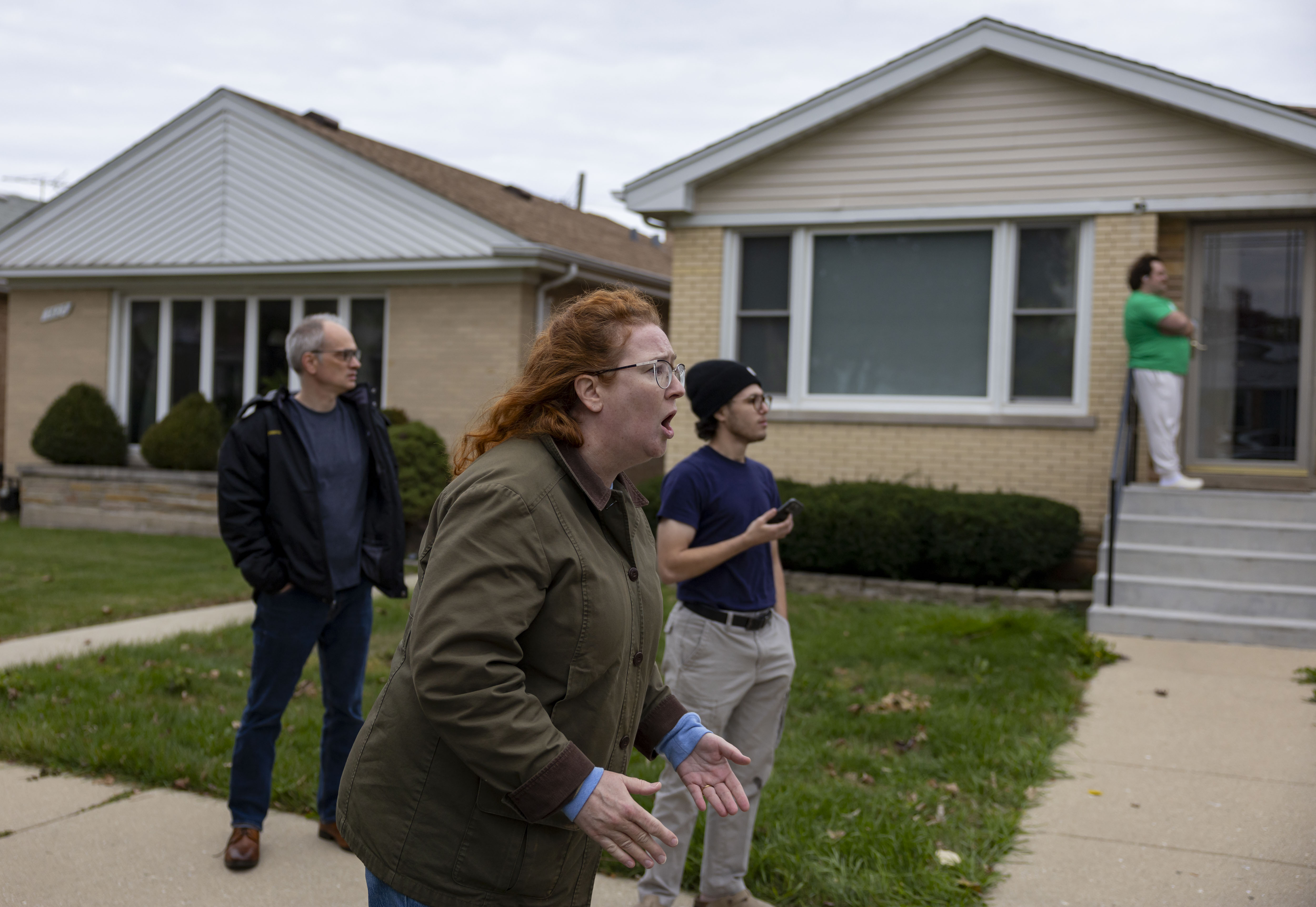 Neighbor Charity Hines yells as U.S. Border Patrol agents detain...