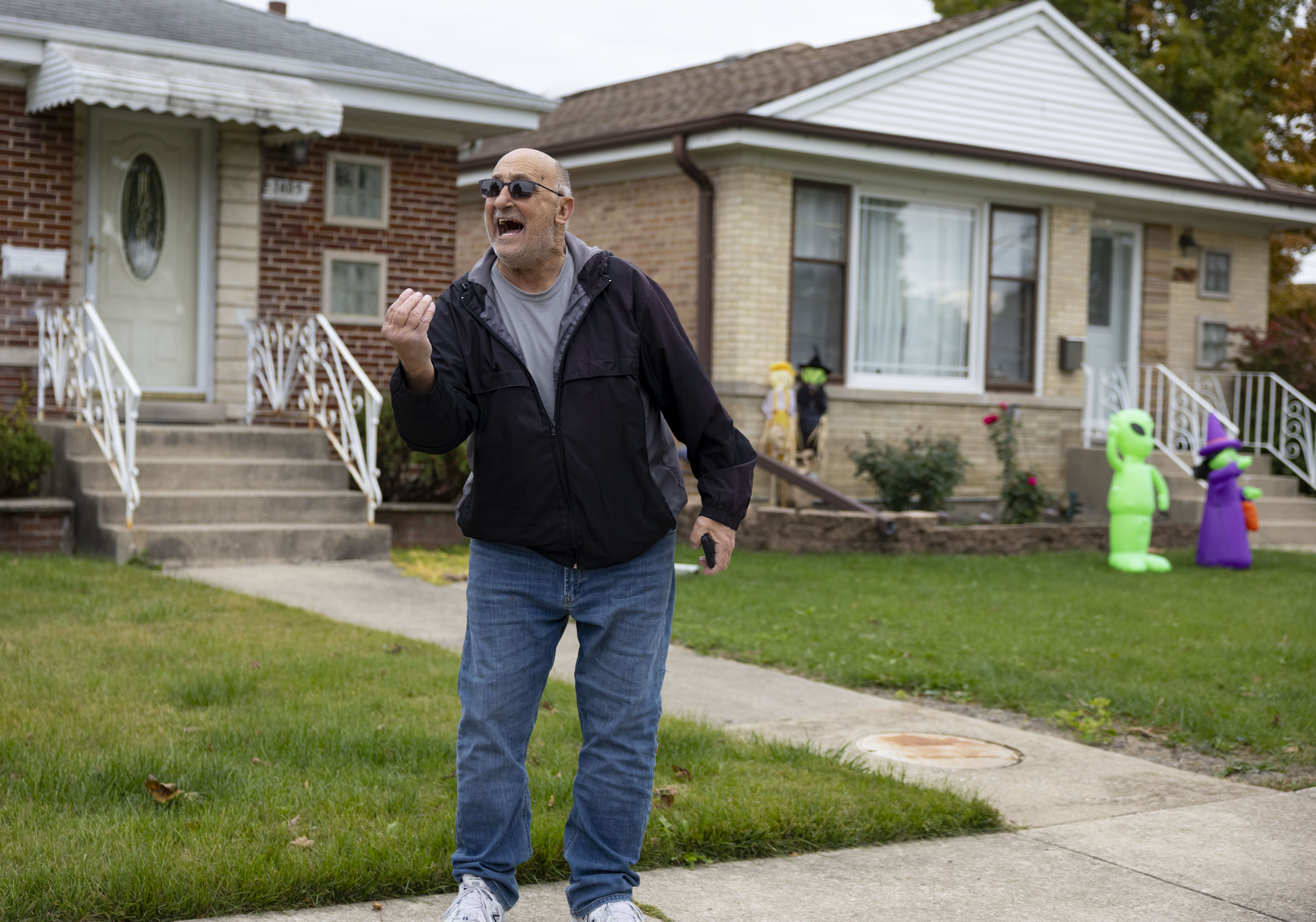 A neighbor yells as U.S. Border Patrol agents detain a...