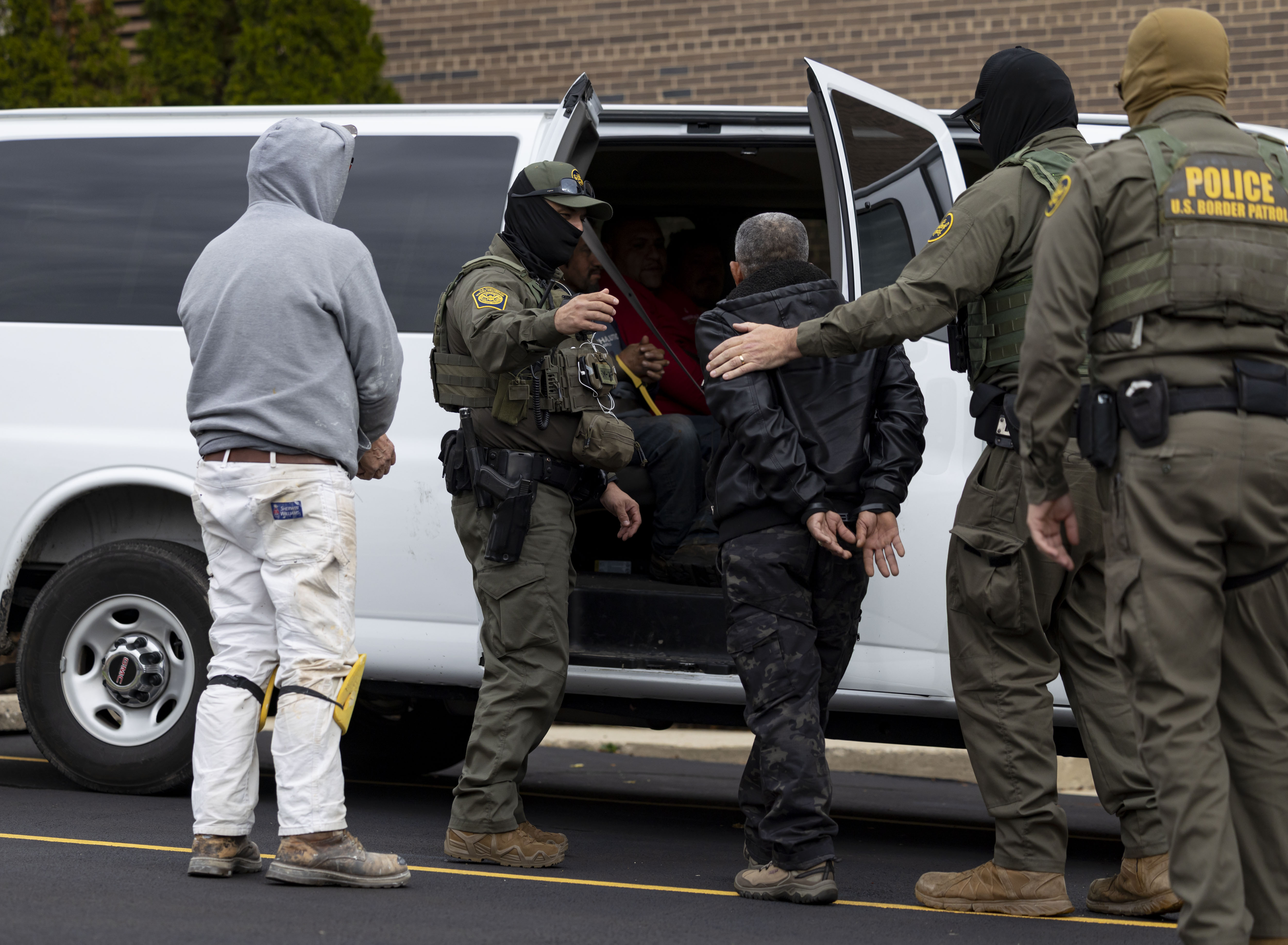 U.S. Border Patrol agents transfer a man they took from...