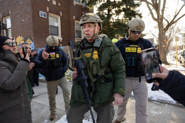 U.S. Border Patrol Cmdr. Gregory Bovino is confronted by residents and protesters during an immigration operation in Little Village on Dec. 16, 2025. (Armando L. Sanchez/Chicago Tribune)