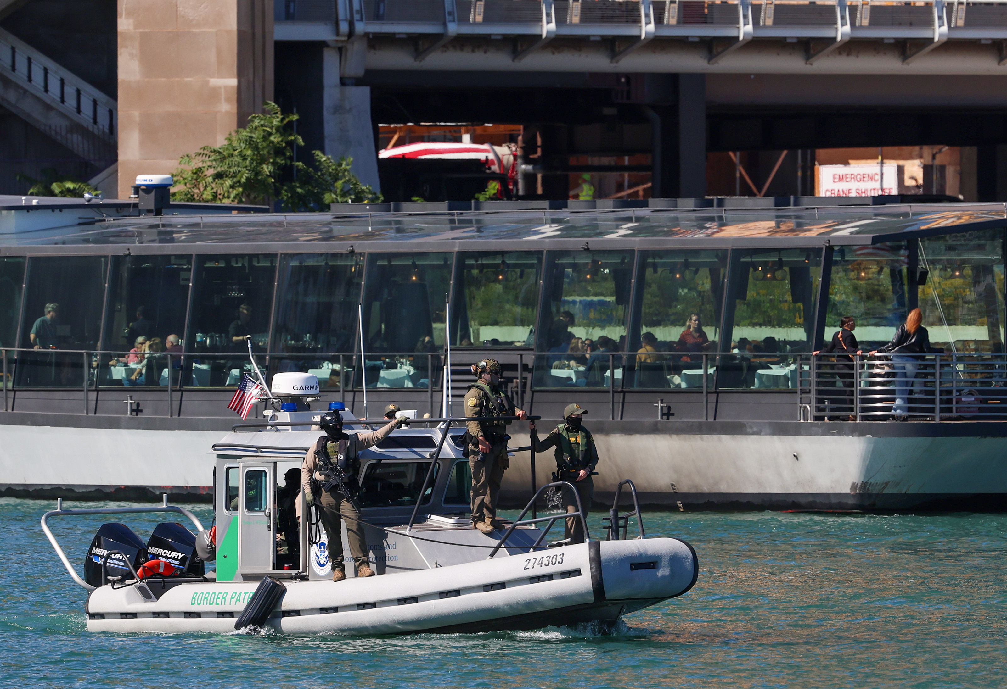 A U.S. Border Patrol boat with armed federal agents head...