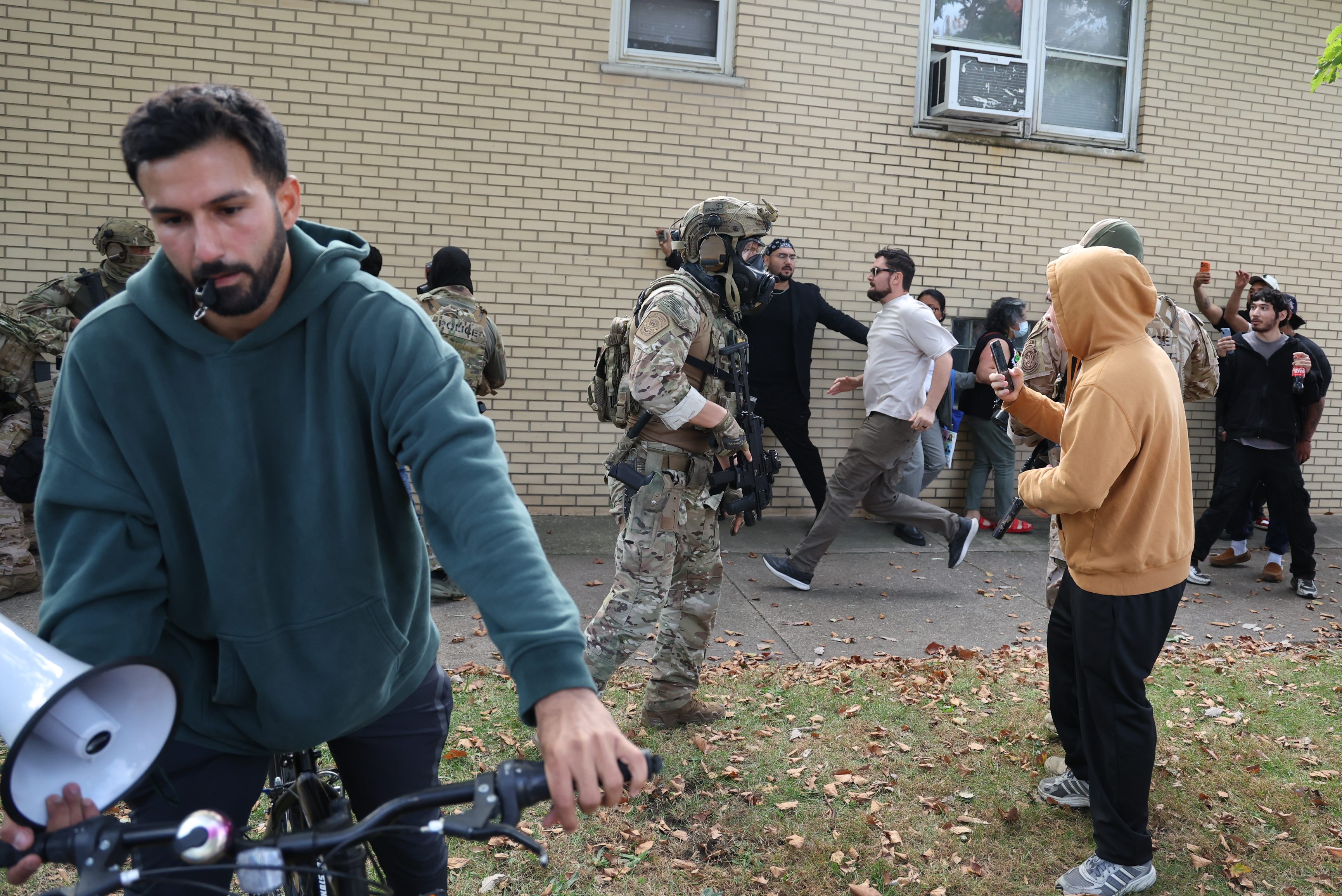 U.S. Border Patrol agents are confronted by community members in...