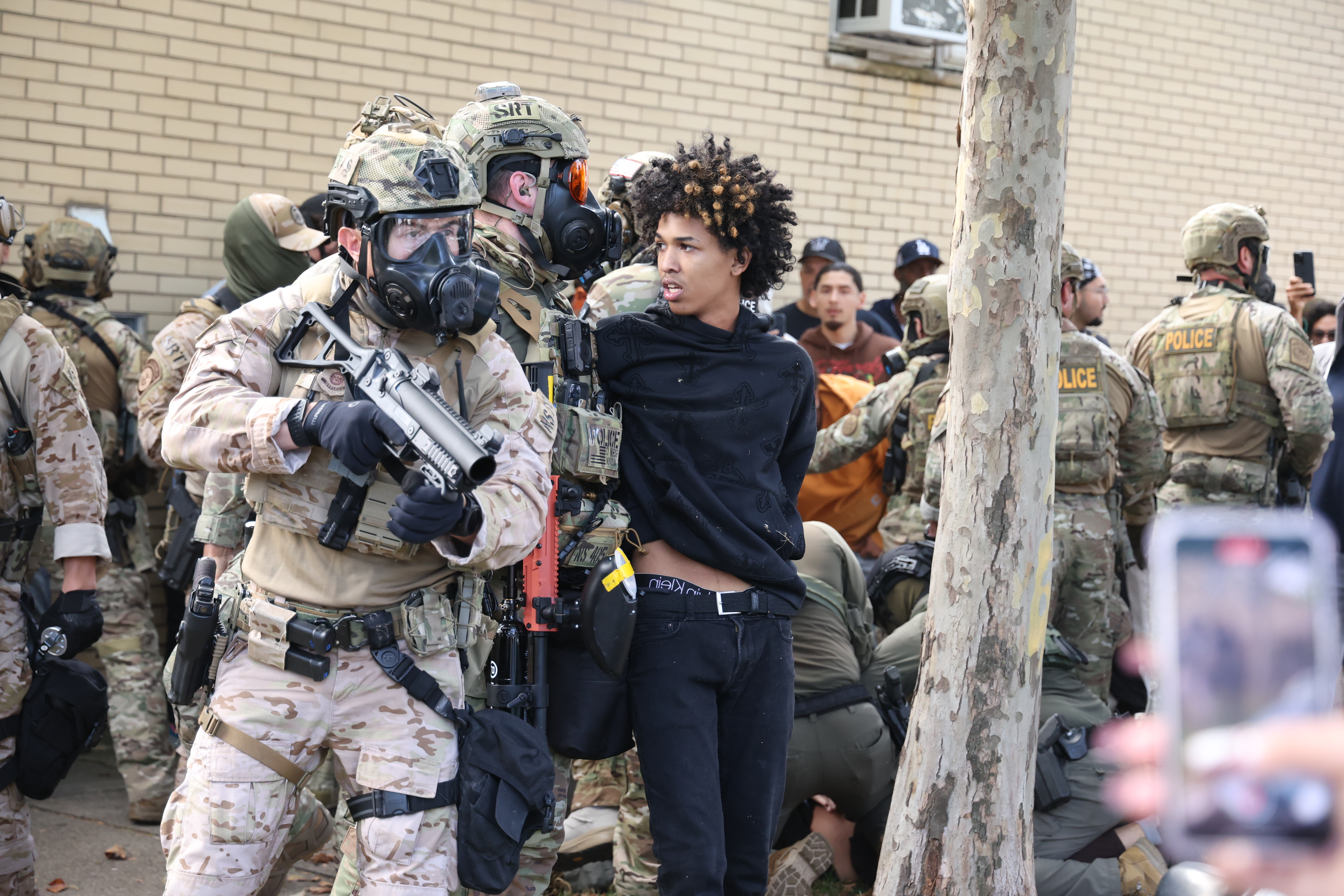 U.S. Border Patrol agents are confronted by community members in...