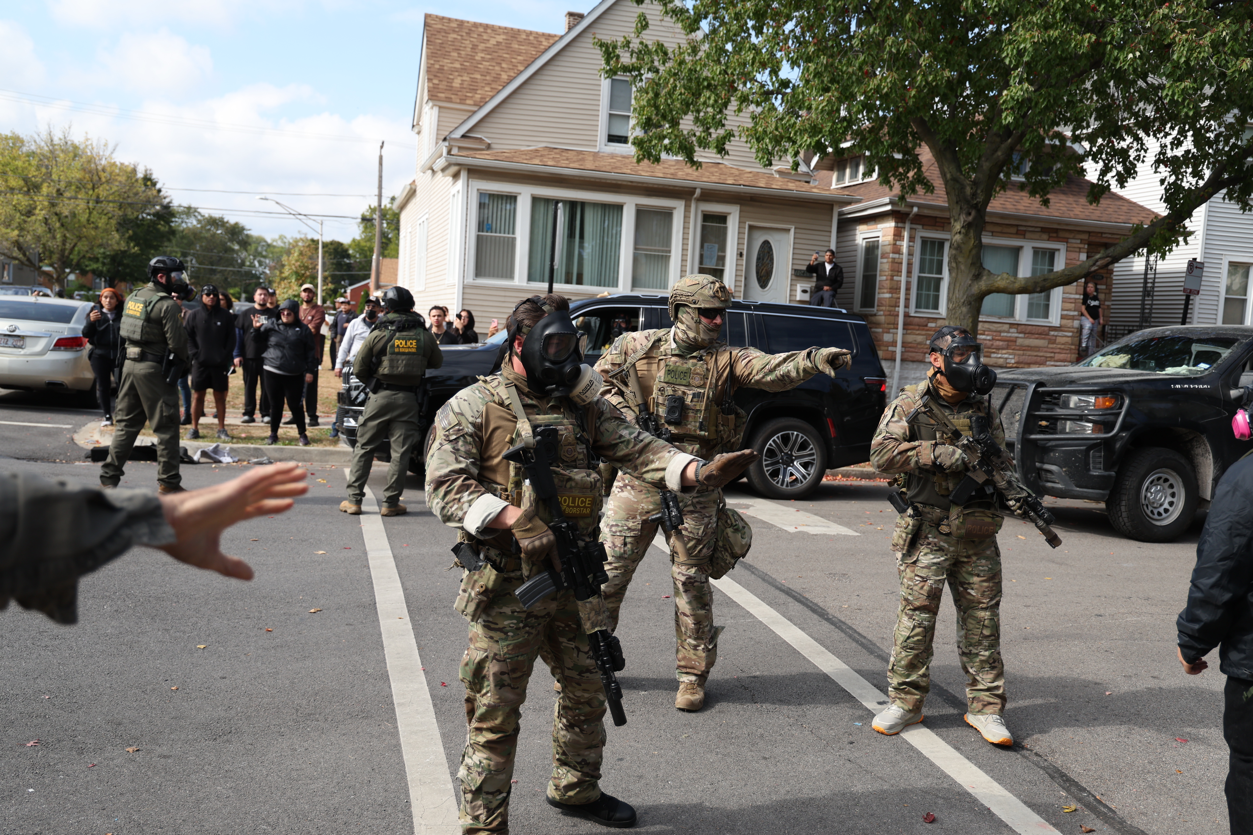 U.S. Border Patrol agents are confronted by community members in...