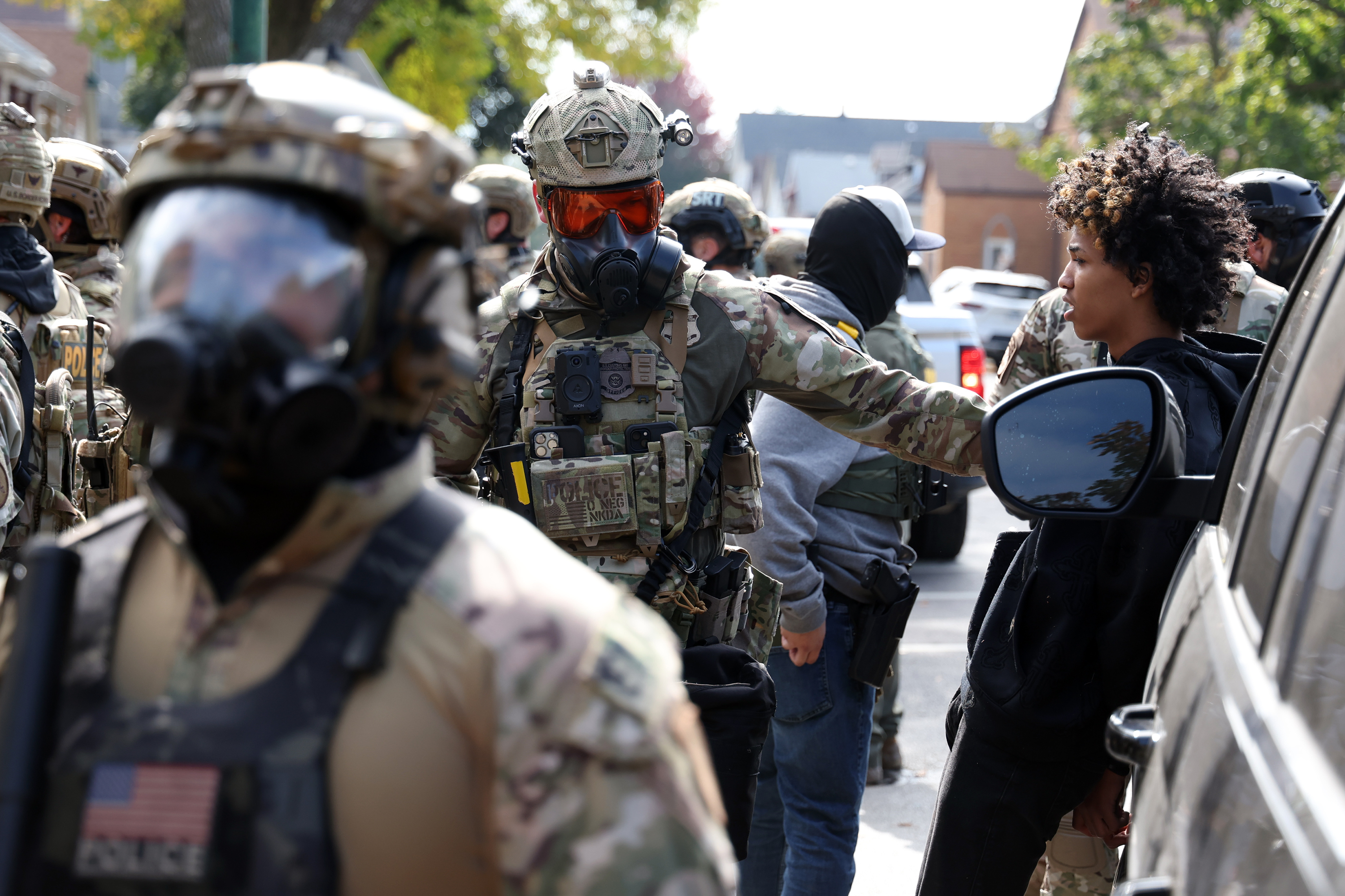 A person is detained by a Border Patrol agent after...