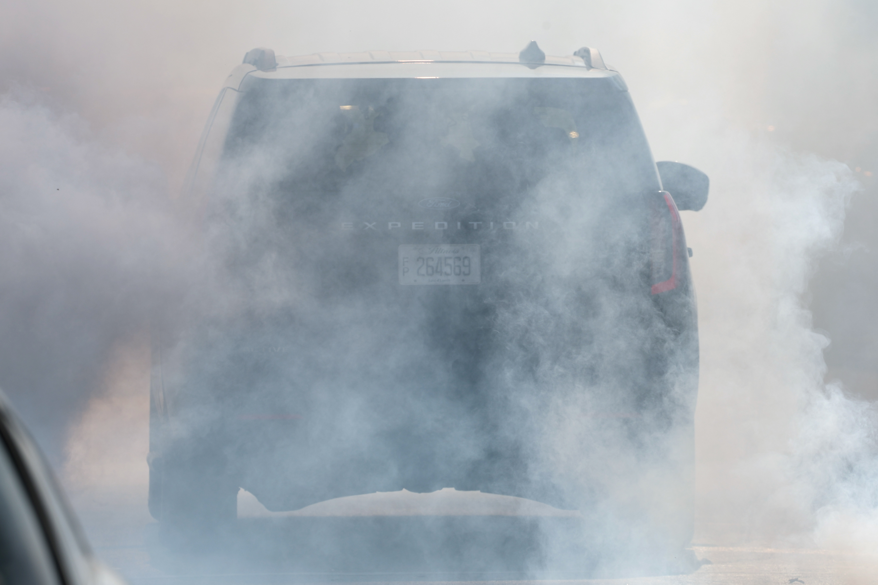 Border Patrol agents leave in a cloud of tear gas...
