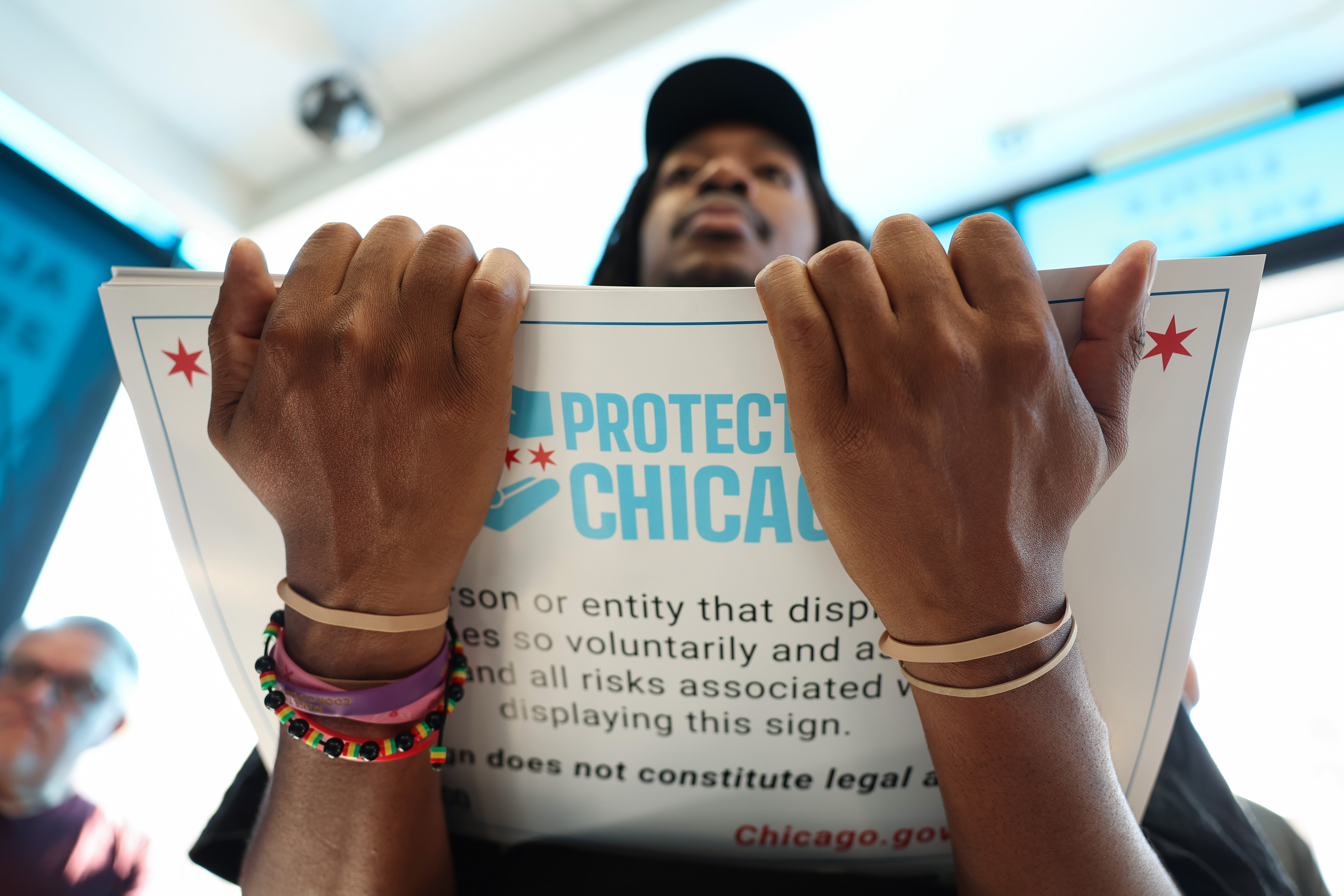 Community organizer Nino Brown holds a stack of 