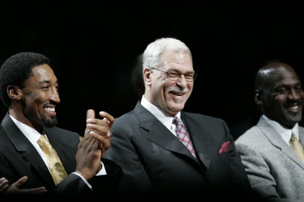 Scottie Pippen, left, with former coach Phil Jackson, center, and teammate Michael Jordan during the half-time ceremony where Pippen's No. 33 jersey was retired on Dec. 9, 2005, at the United Center in Chicago. (Charles Cherney/Chicago Tribune)