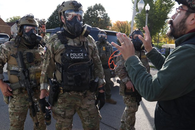Angry crowds face off with federal agents after a raid at the Discount Mall on West 26th Street in Chicago's Little Village neighborhood on Oct. 23, 2025. (Antonio Perez/Chicago Tribune)