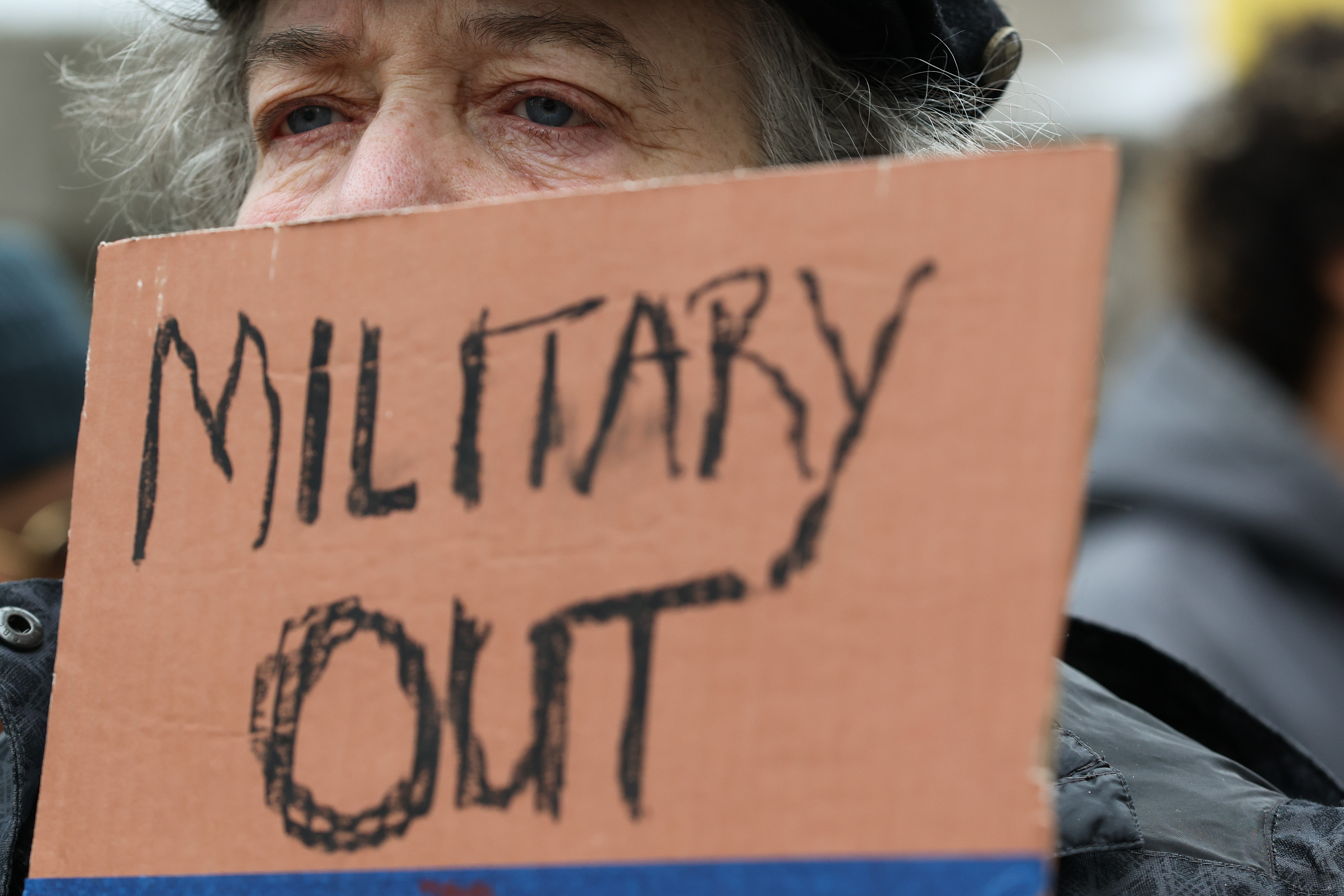 Pat Ruch holds a sign during a demonstration to call...