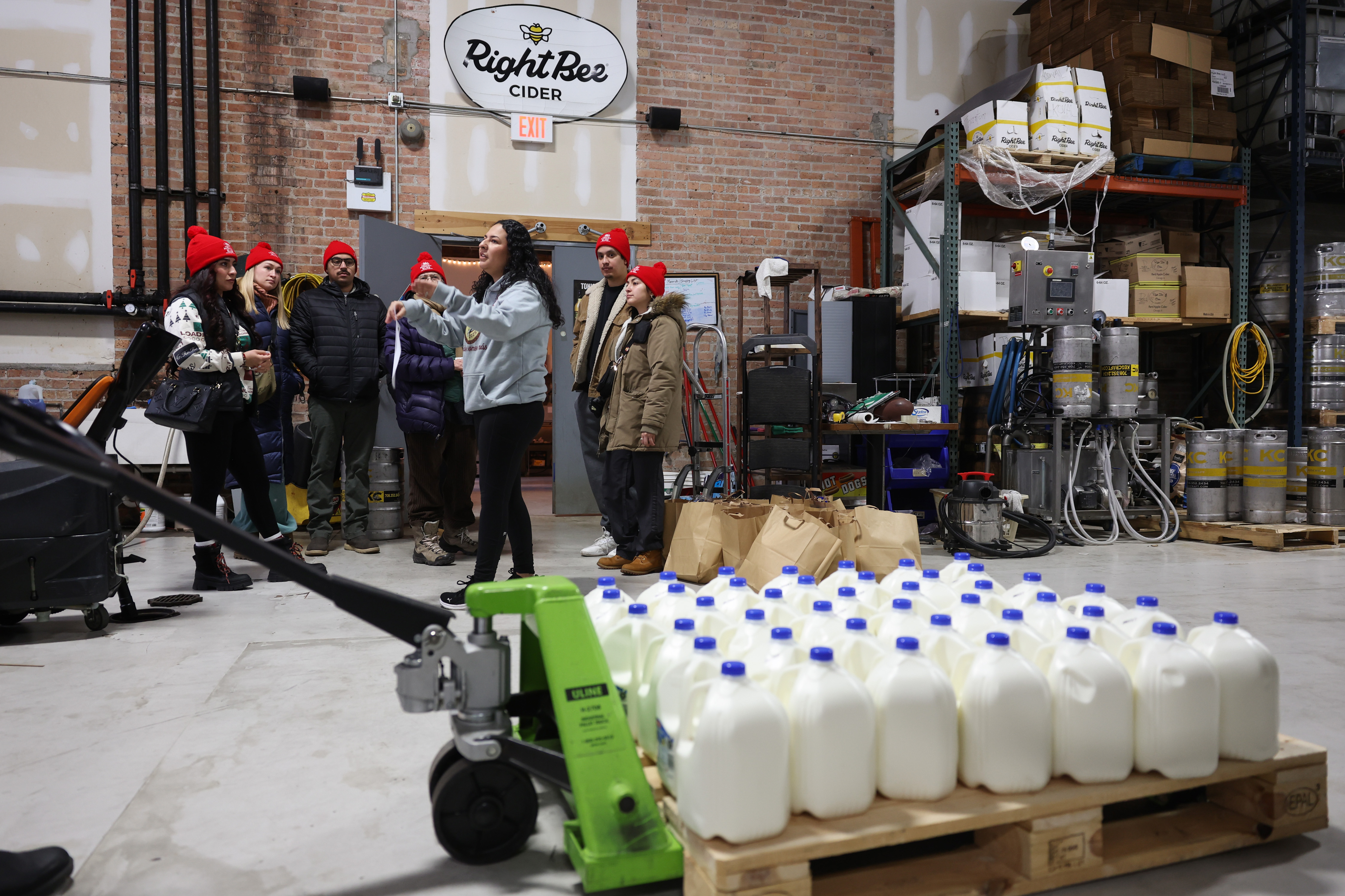 Diana Torres-Barron, center left, gives instructions to volunteers for a...