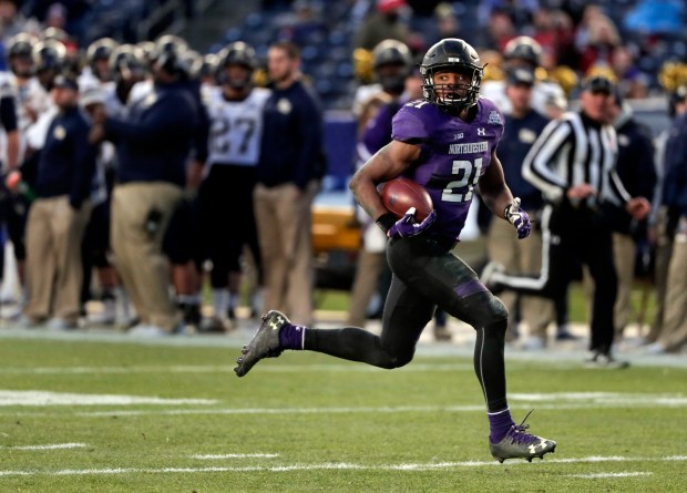 In this Dec. 28, 2016, file photo, Northwestern running back Justin Jackson (21) runs for a touchdown against Pittsburgh during the third quarter of the Pinstripe Bowl NCAA college football game in New York. (Julie Jacobson/AP)