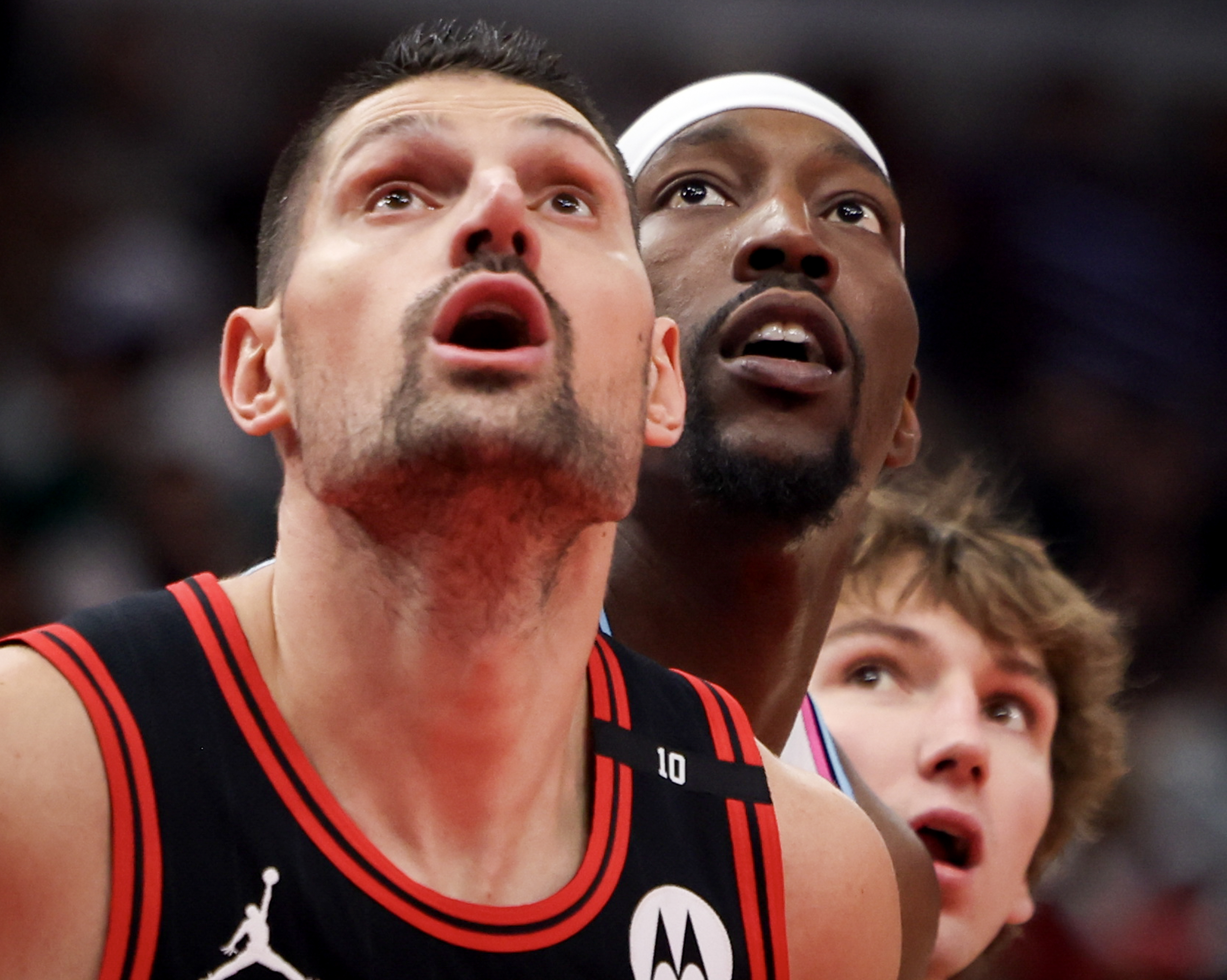 April 9: From left, Chicago Bulls center Nikola Vucevic, Miami...