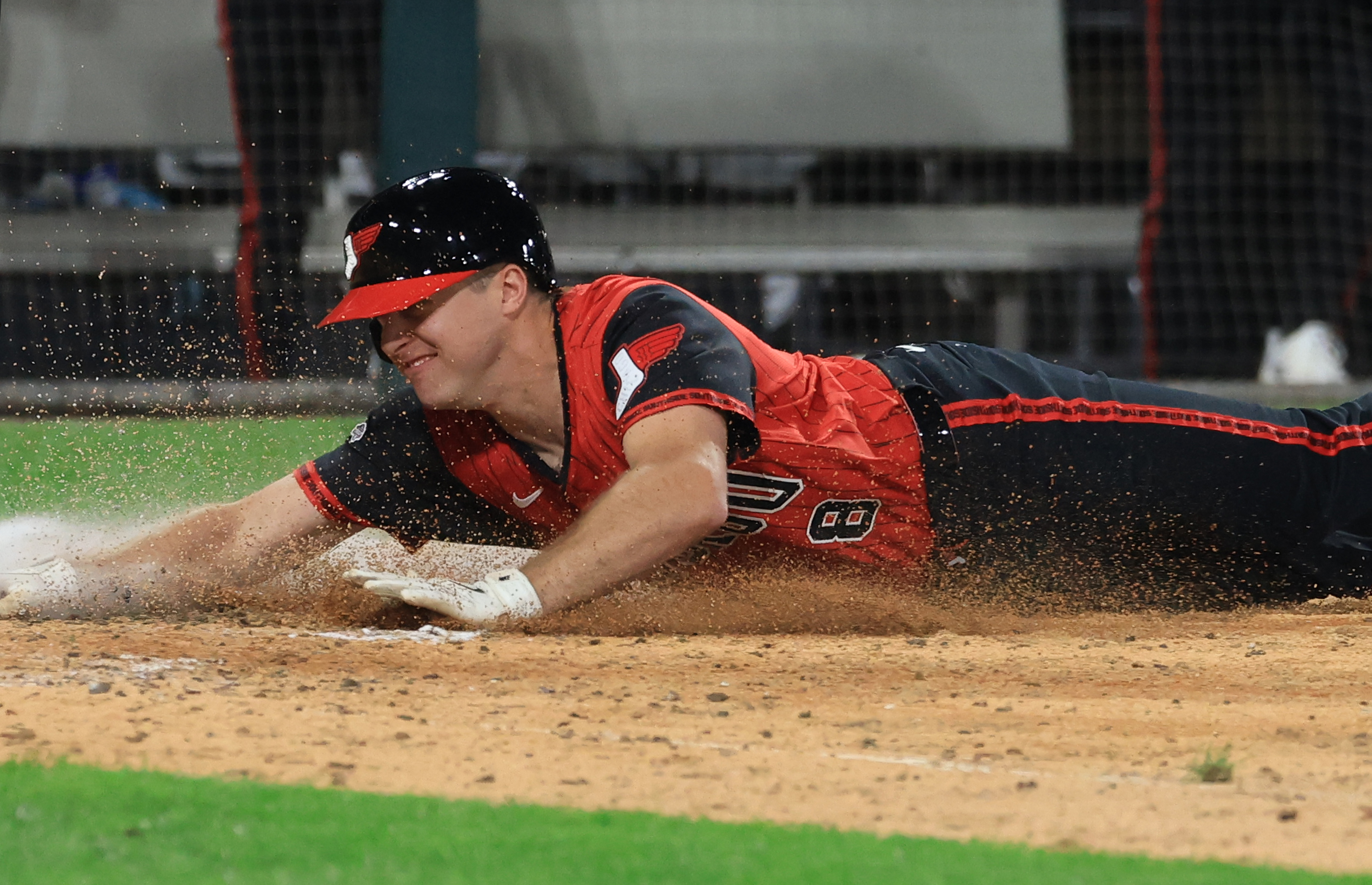 White Sox catcher Kyle Teel dives for the plate to...