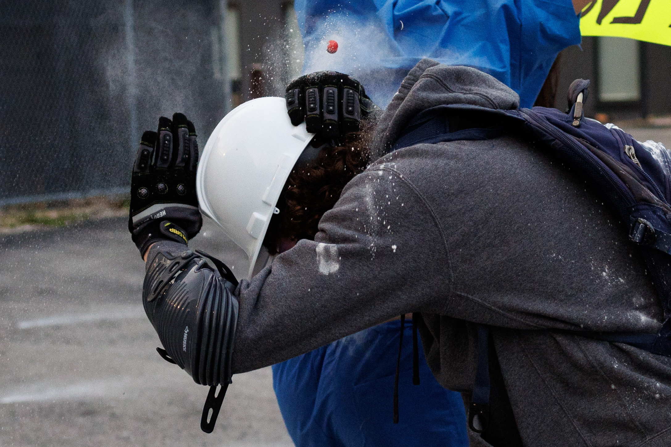 A protester is shot with a pepper ball outside the...