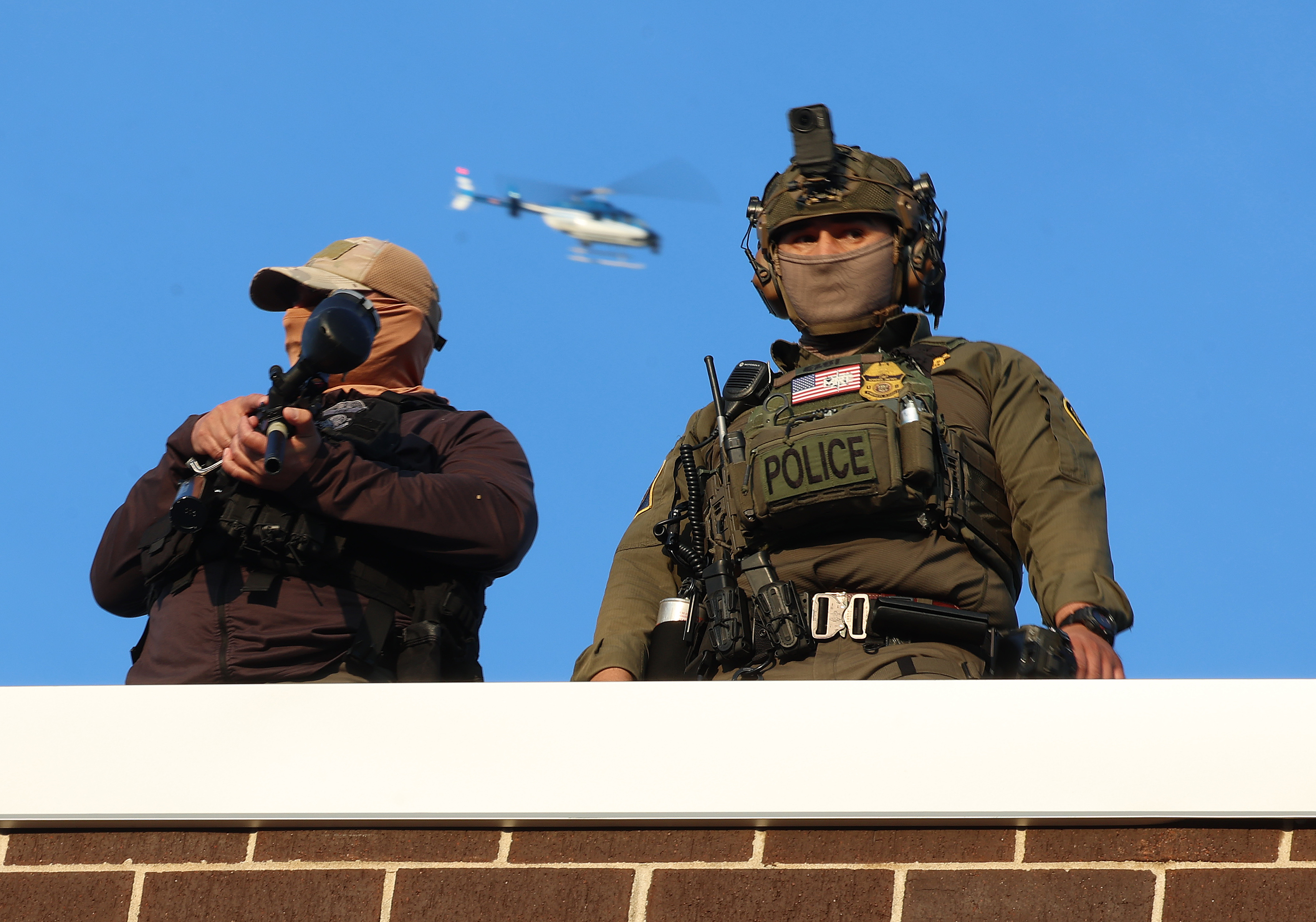 Federal agents stand on the roof of theÂ Broadview Immigration and...