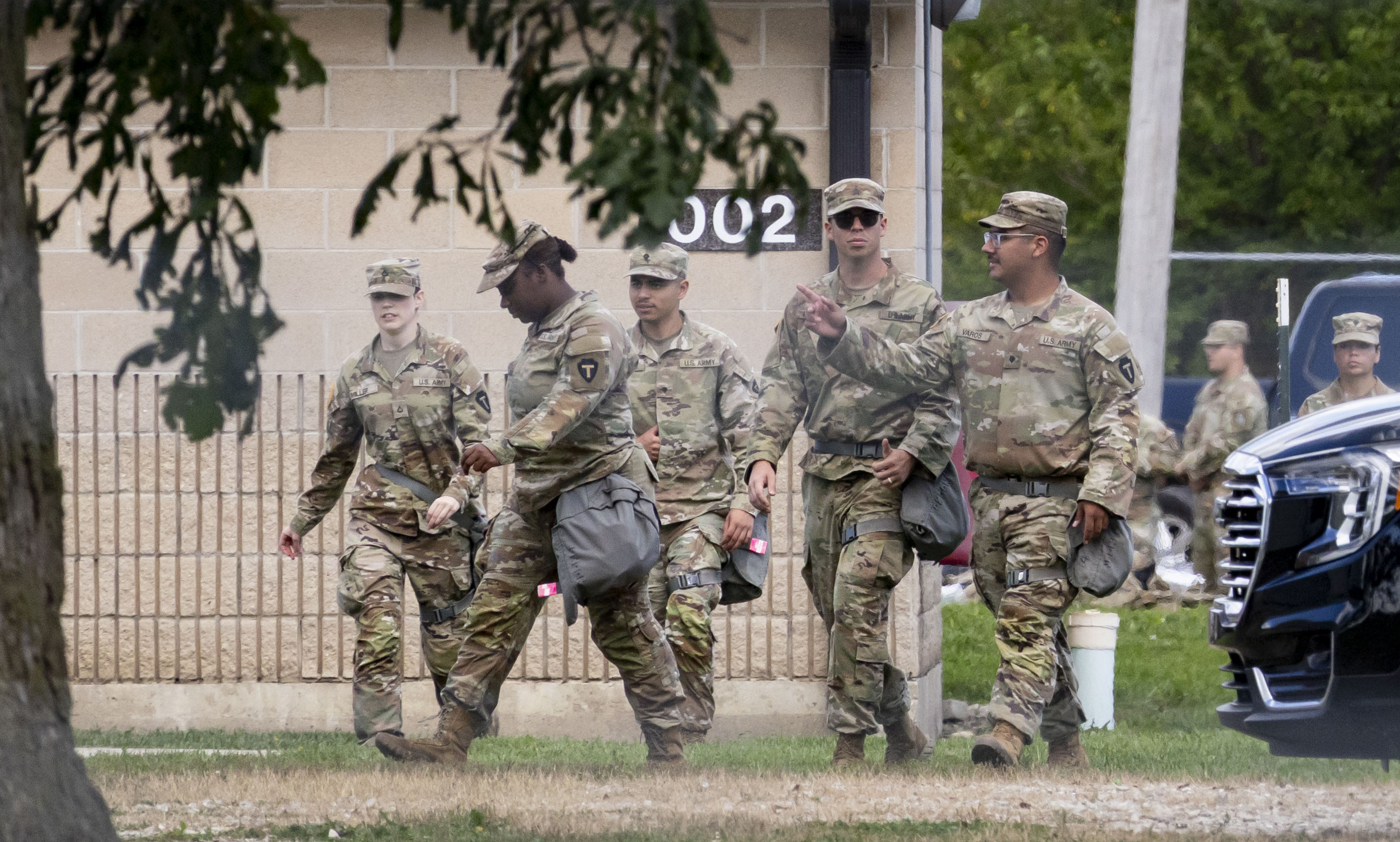 Members of the Texas National Guard are seen at the...